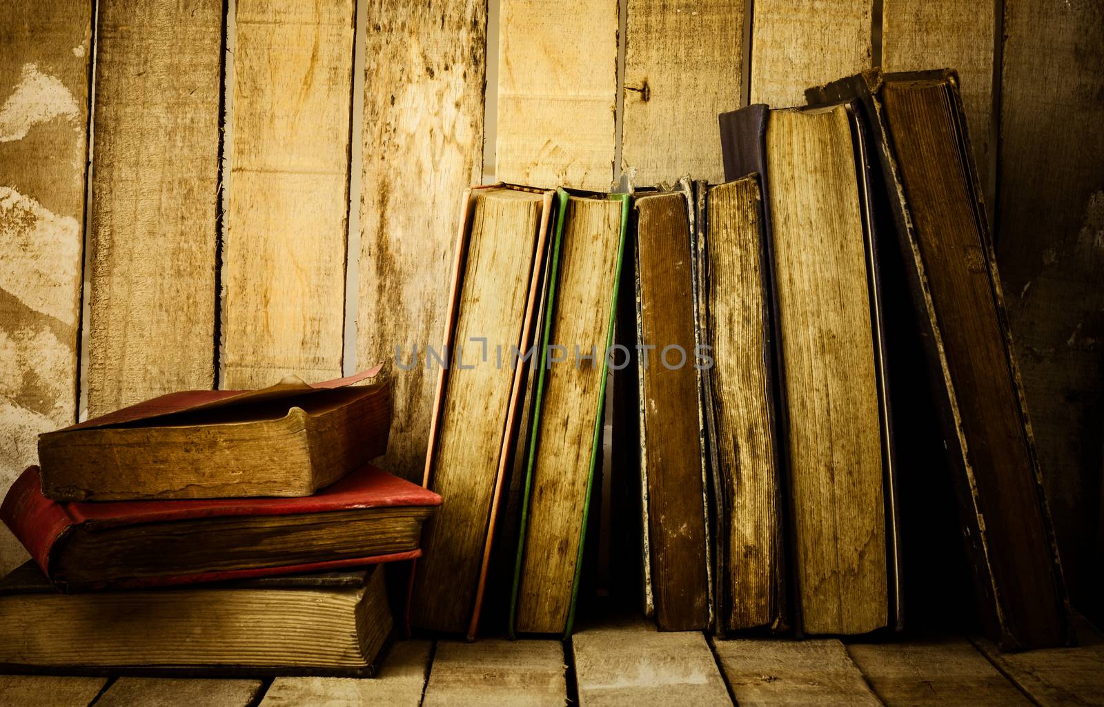 Old books on the wooden background.