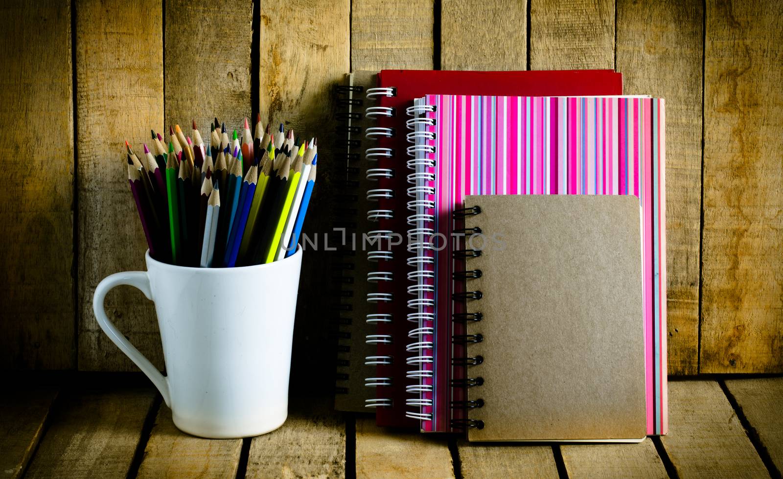 color pencil notebook on a wooden table.