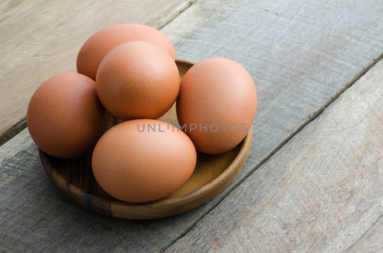 Place the egg in a cup on wood