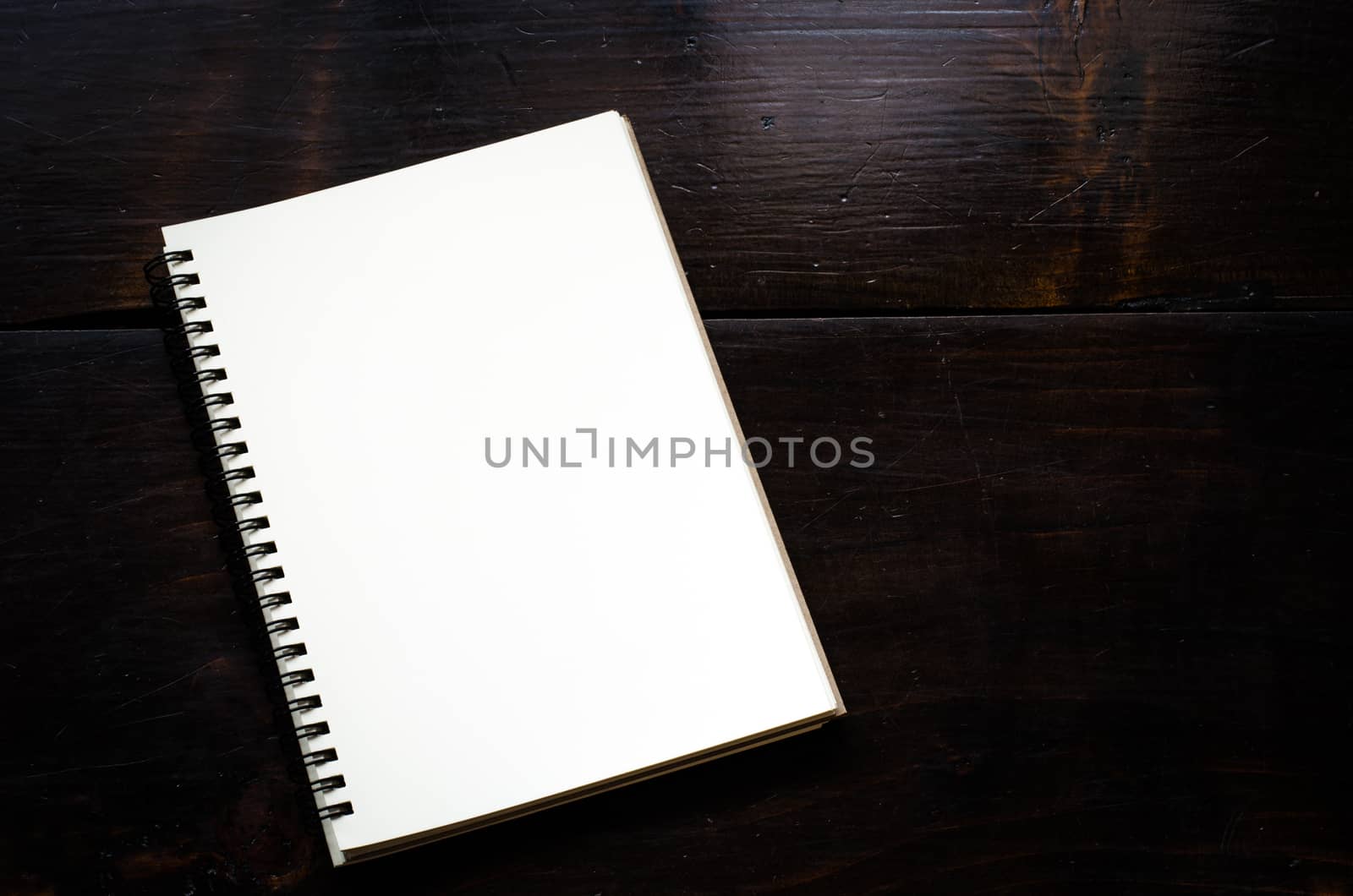 White notebooks laying on black table