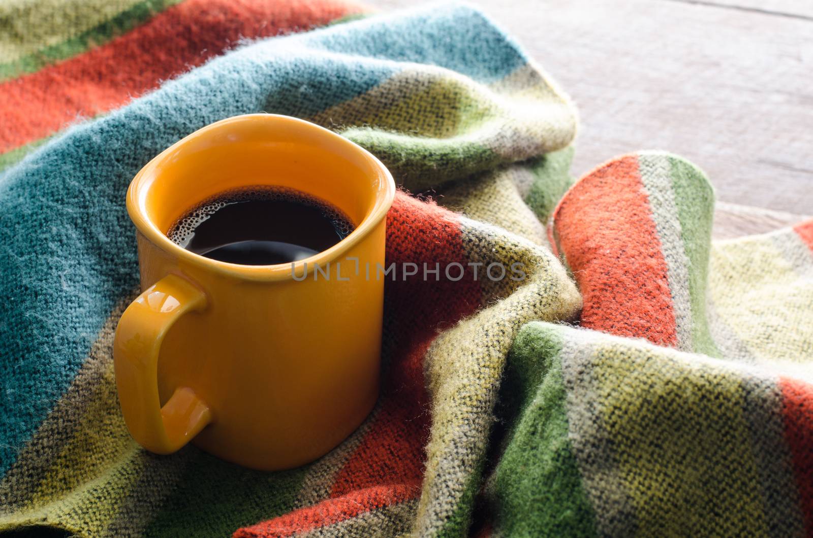 Coffee cups and scarves on a wooden table