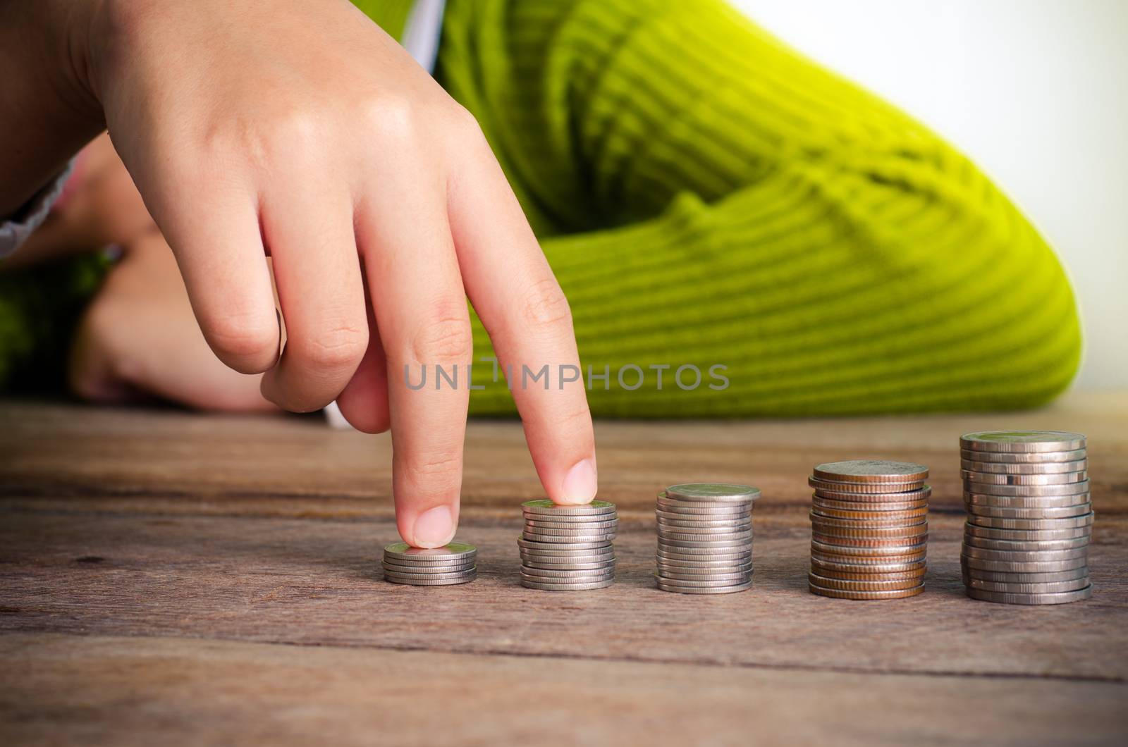 hand put the coin on each line rising - business concept.
