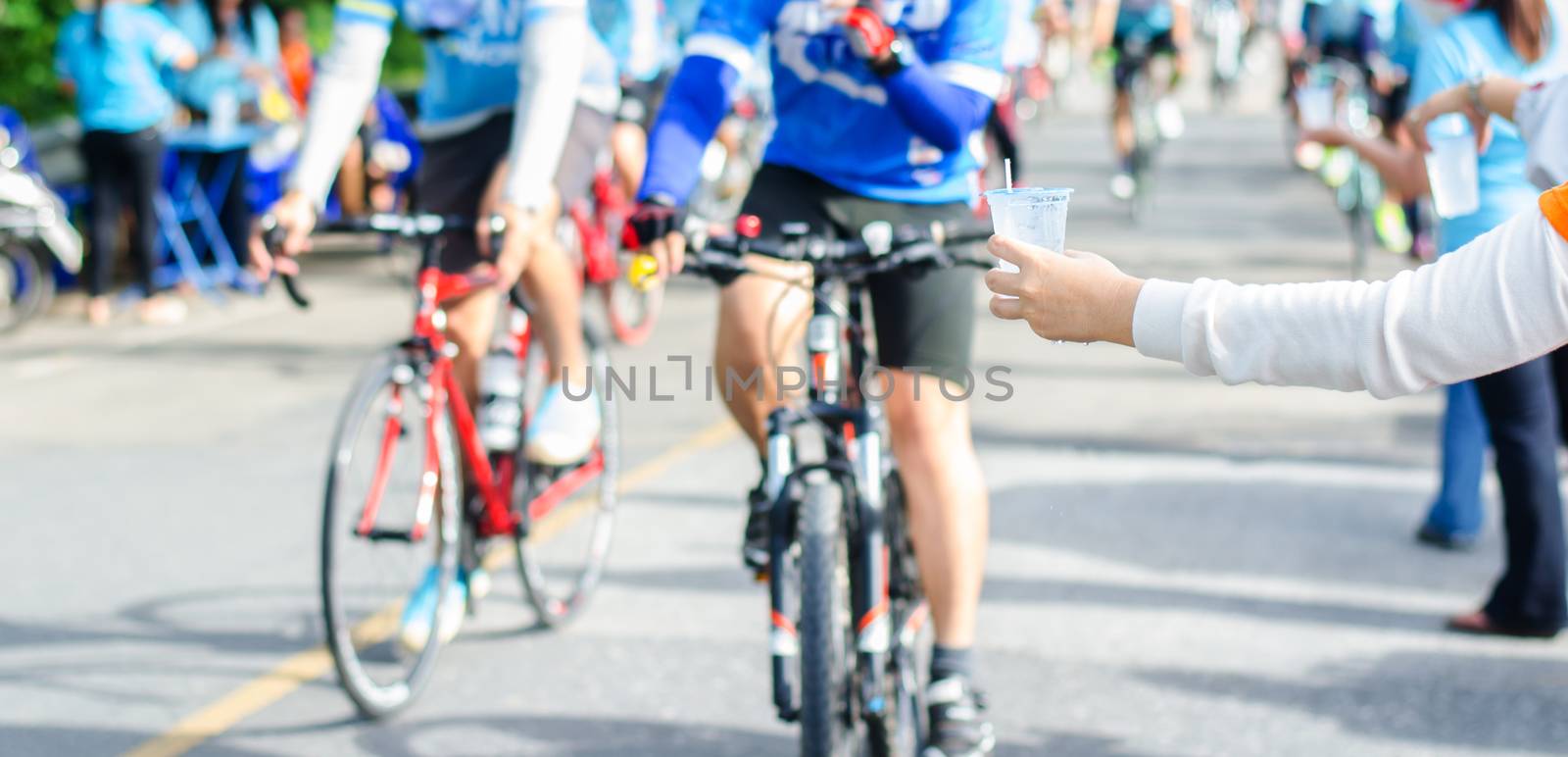 Athletes, cyclists get drinking water by photobyphotoboy