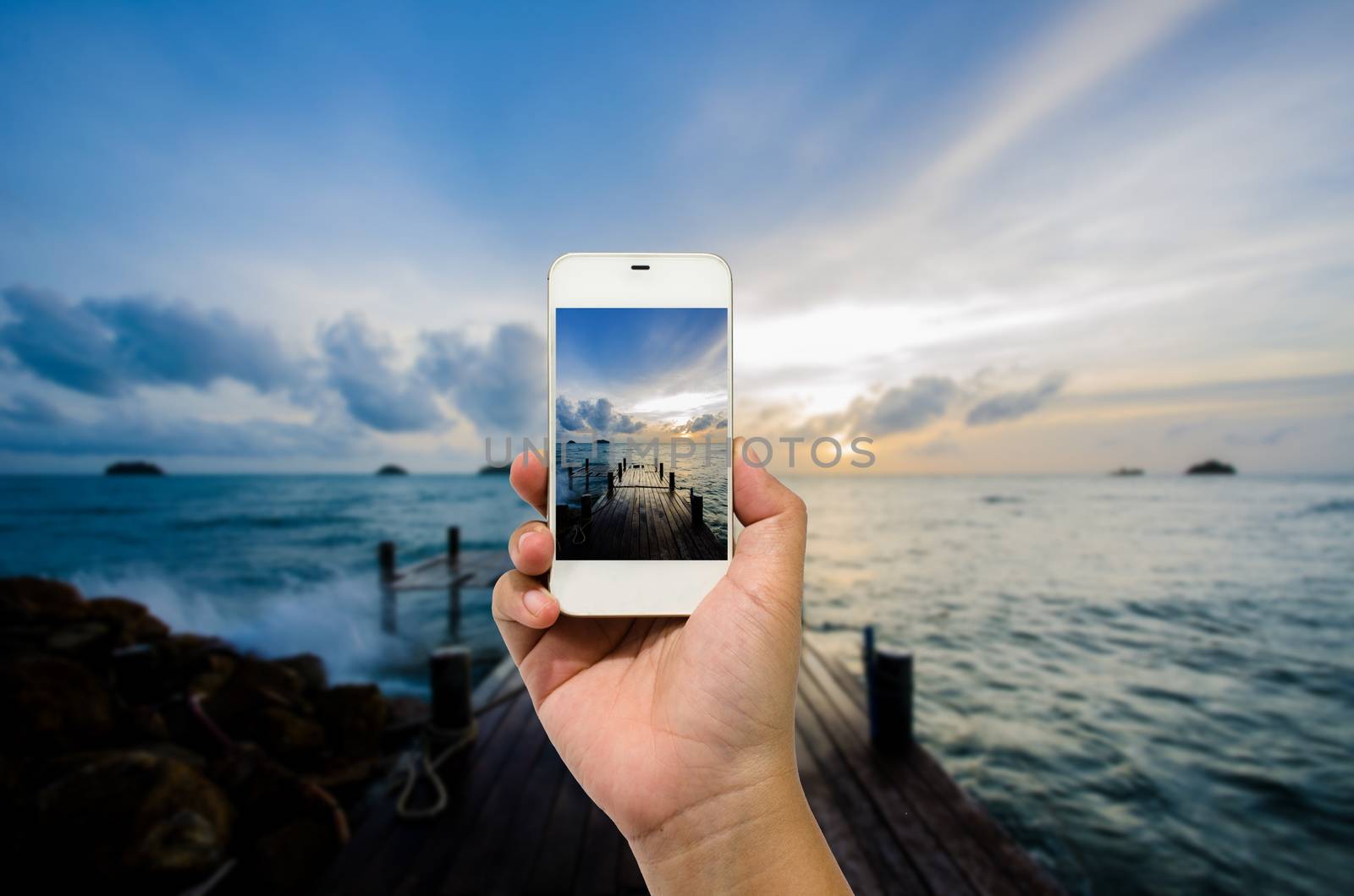 Mobile smart phone behind a of sea beautiful
