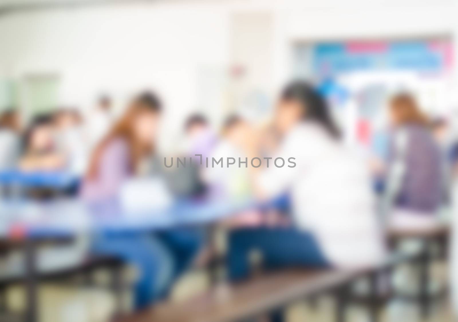 Blur image people enjoy different activities between meals in the cafeteria.