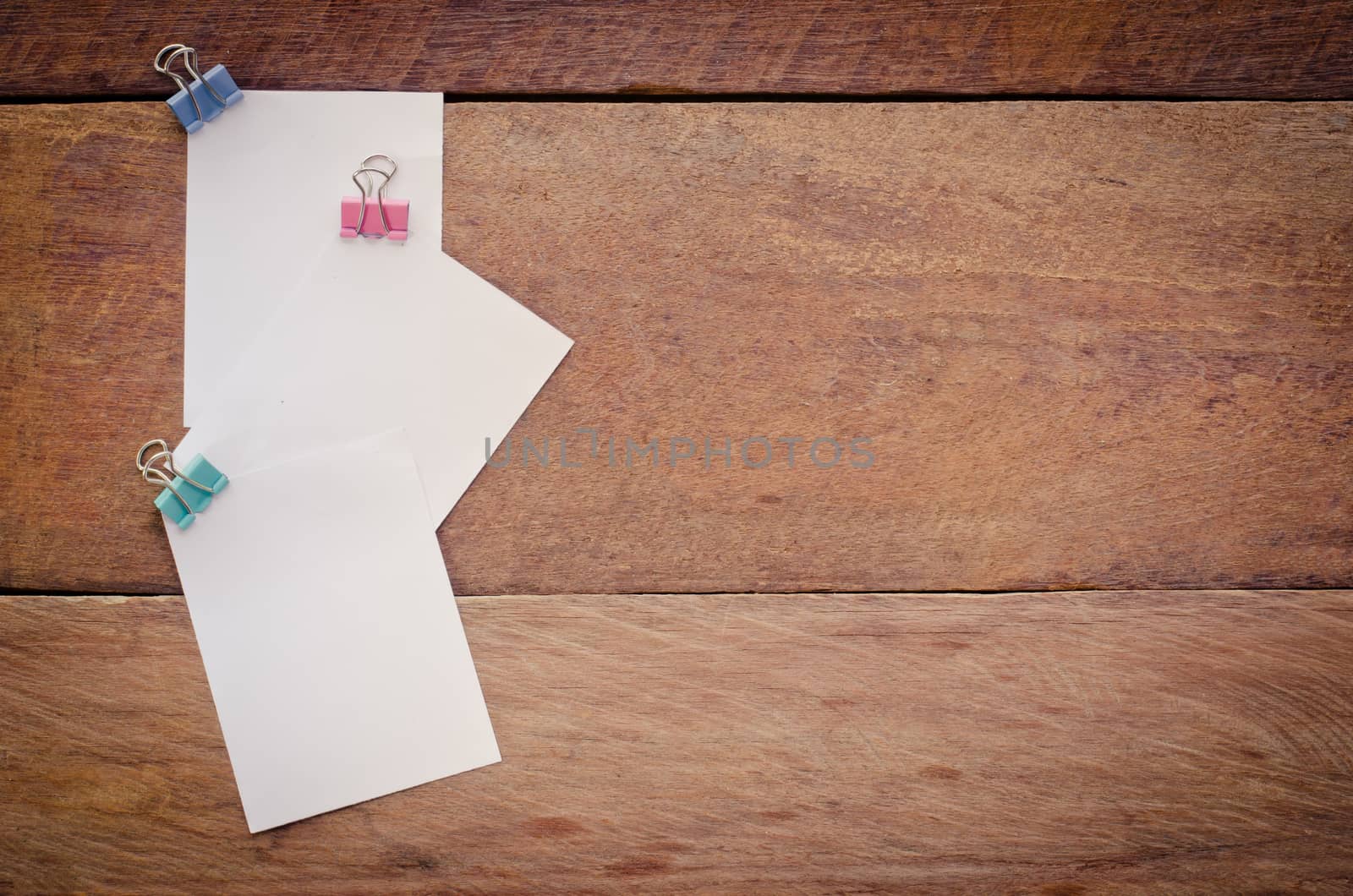 Note paper clip on a wooden floor.