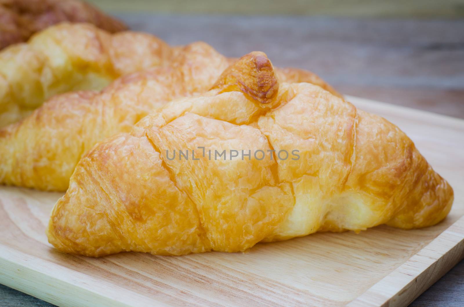 Croissants on plate on wooden table
