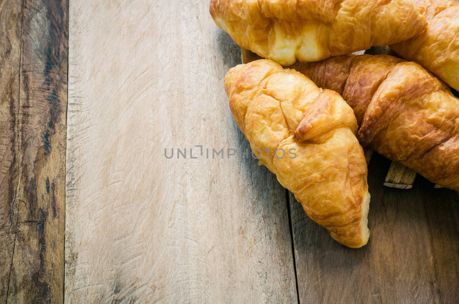 Croissants on plate on wooden table