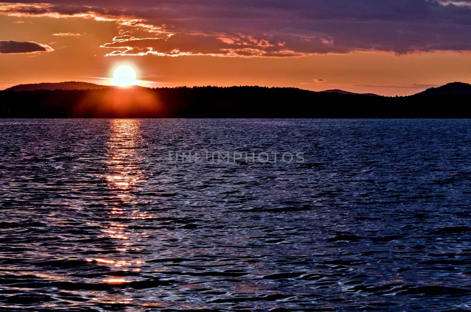 Golden sun sinks over the lake in the evening, golden water, South Ural lake Uvildy