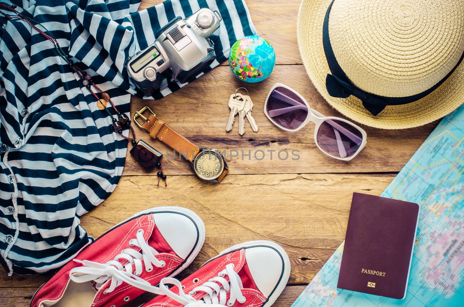 Travel accessories and costume on wooden floor