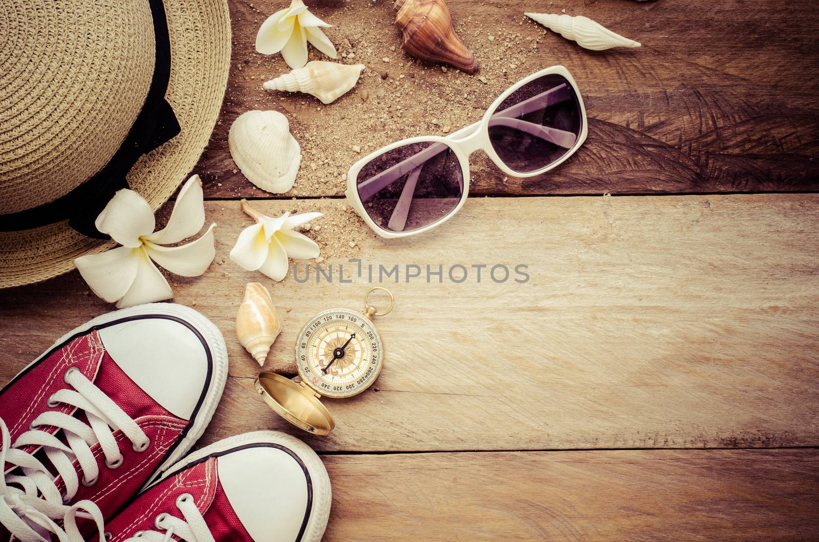 Travel accessories for summer on wooden background