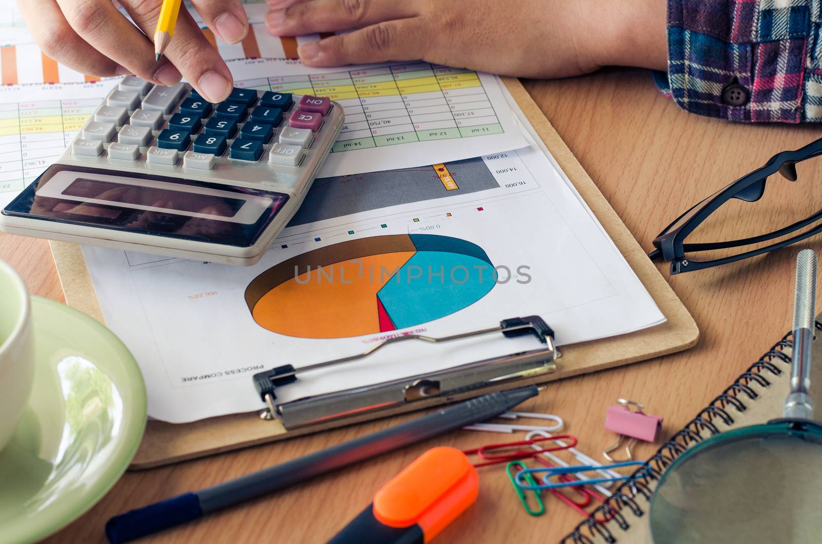Businessman working on a desk numerical analysis, financial accounting, sales graphs.
