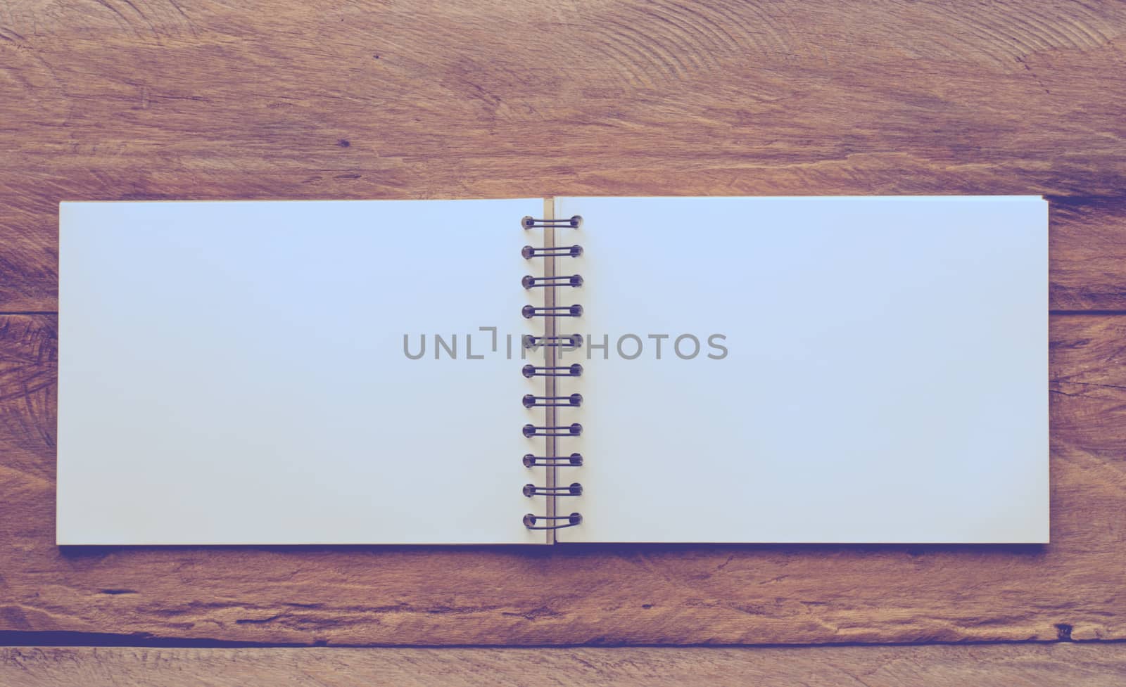 Notebooks white on a wooden table. by photobyphotoboy