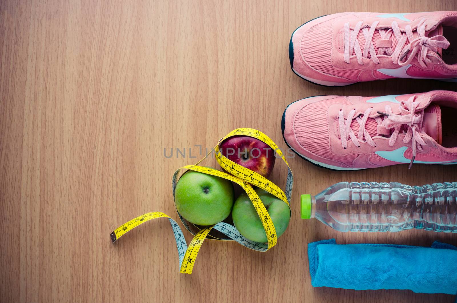 fitness concept with Exercise Equipment on wooden background.