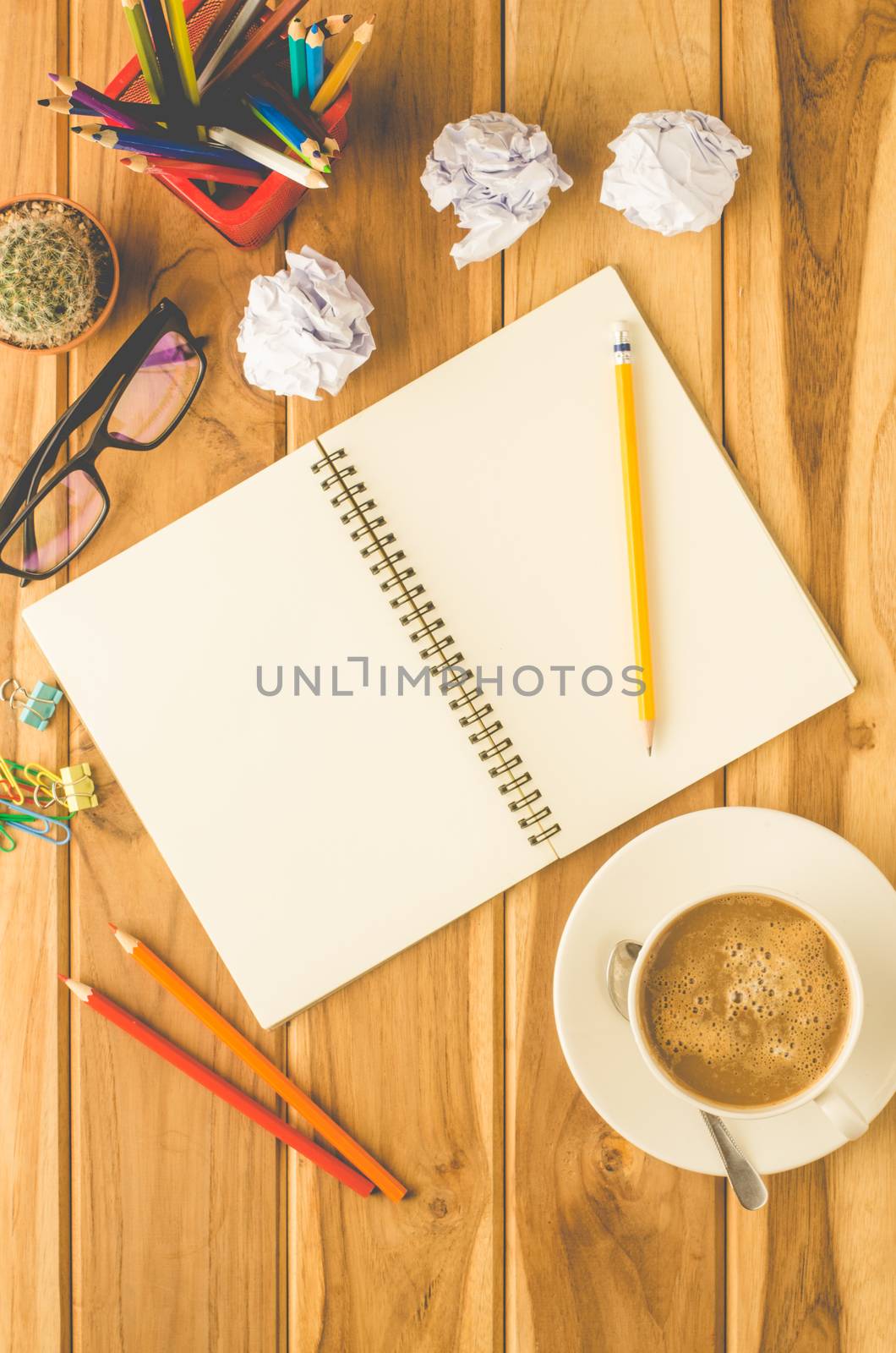 coffee cup, chart, pen, notebook and accessory for work on wooden table. by photobyphotoboy
