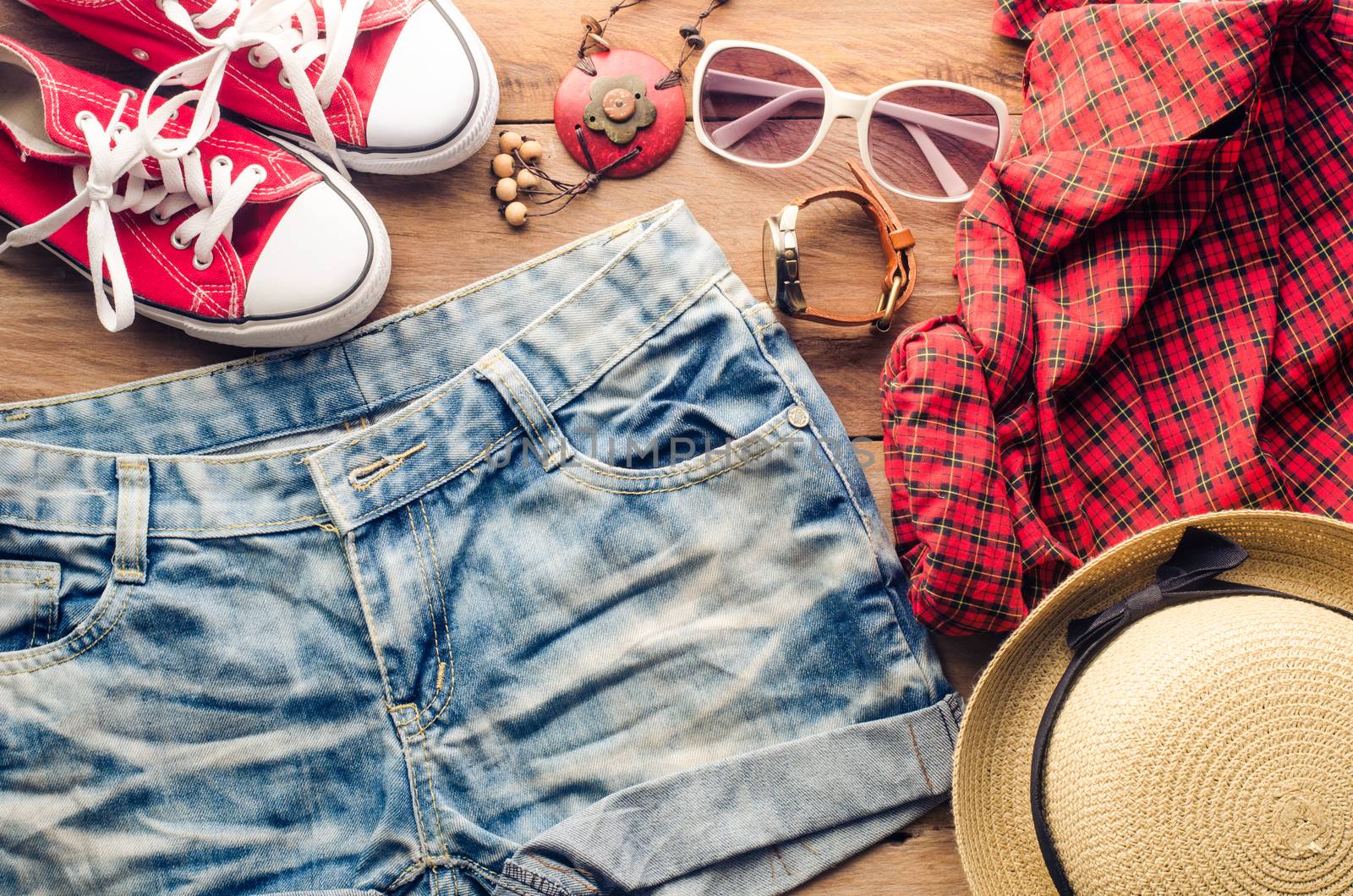 Clothing and accessories for women with summer on wood floor