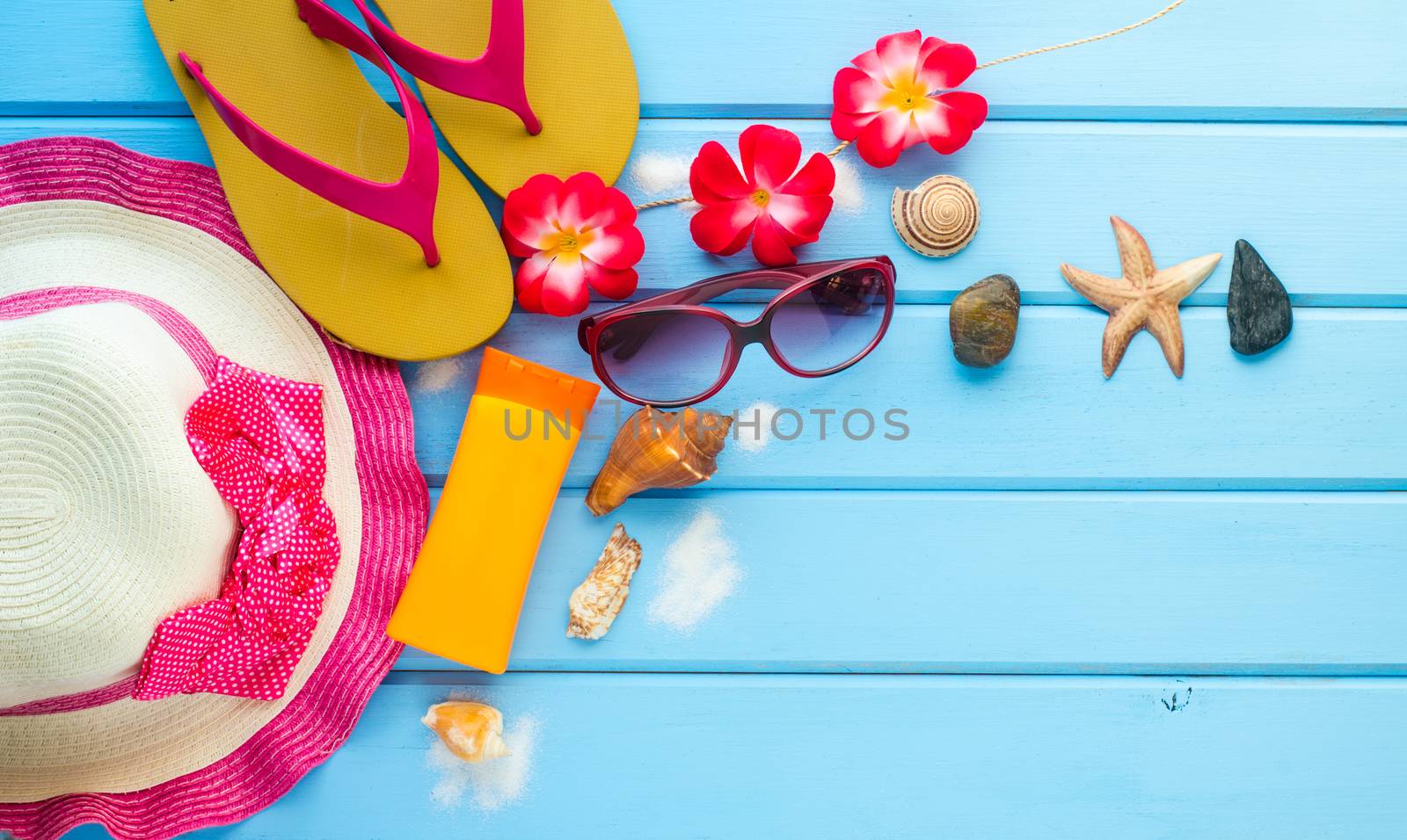 accessories for summer on blue wooden floor