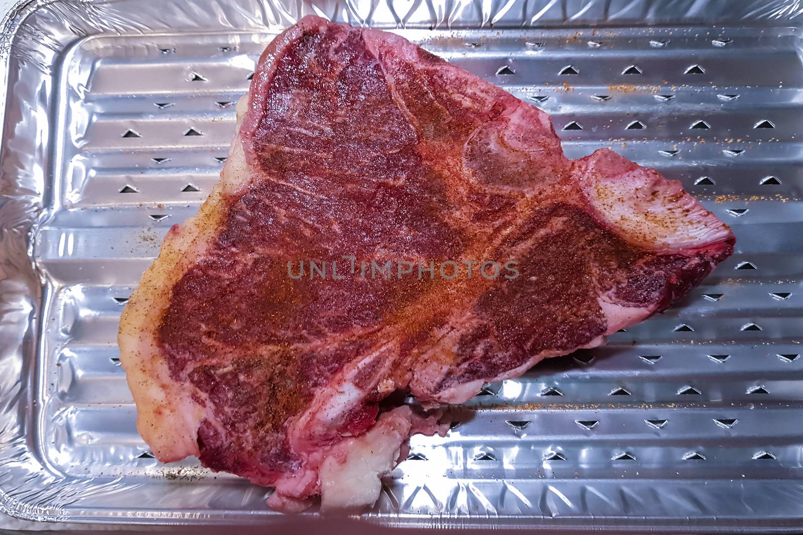 Close-up view of a Marbled Bone steak on an alu grill cup