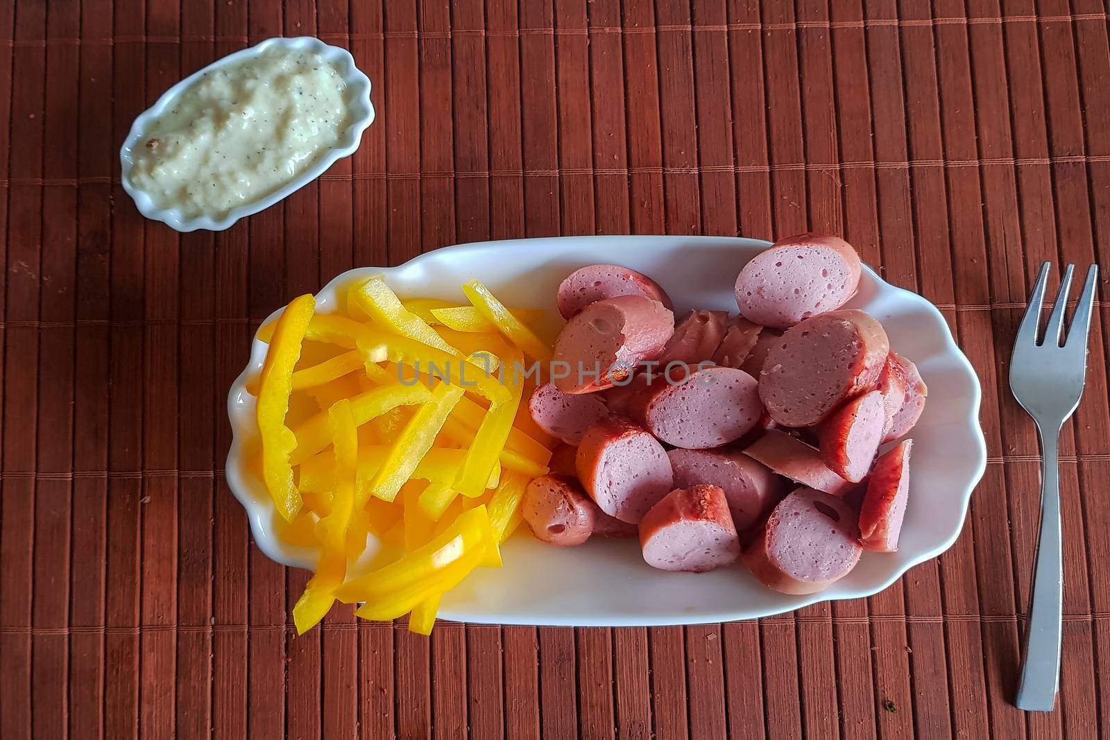 Viennese sausages with yellow peppers cut into strips as French fries substitutes. Low carb food