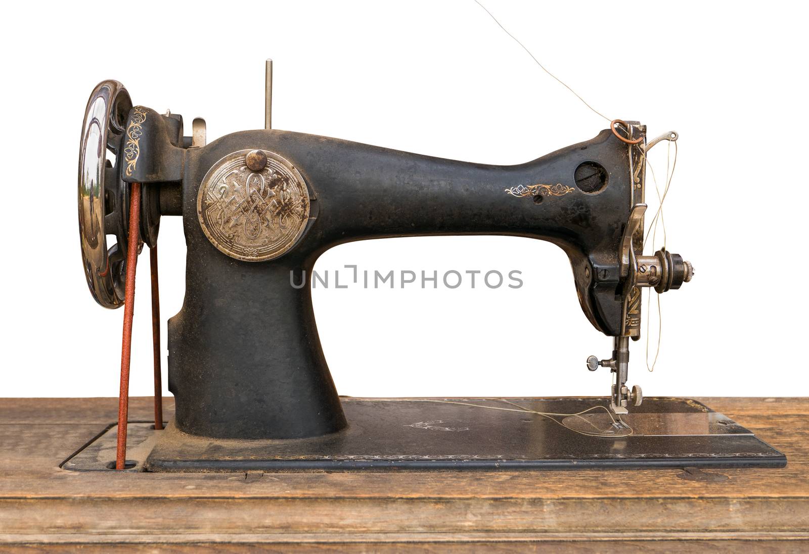 An Isolated Antique Sewing Machine On A Wooden Table With A White Background