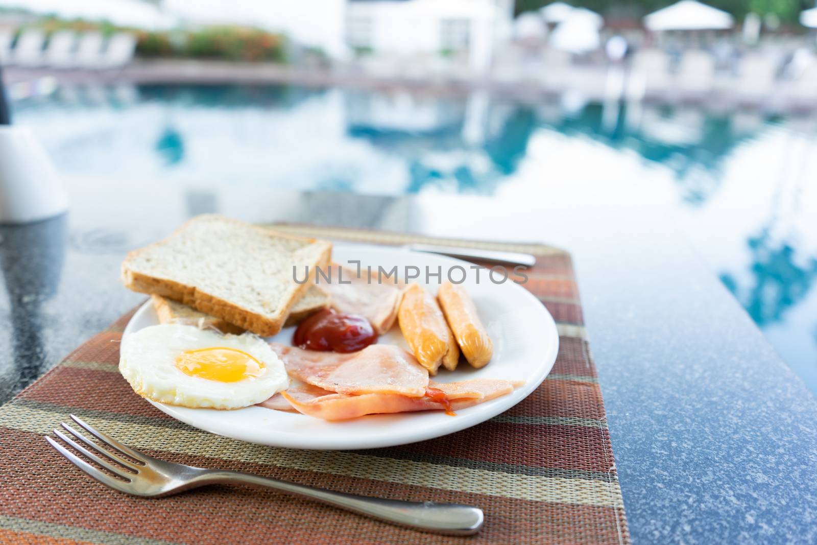 Delicious Breakfast set by the swimming pool at Pattaya, Thailan by littlekop