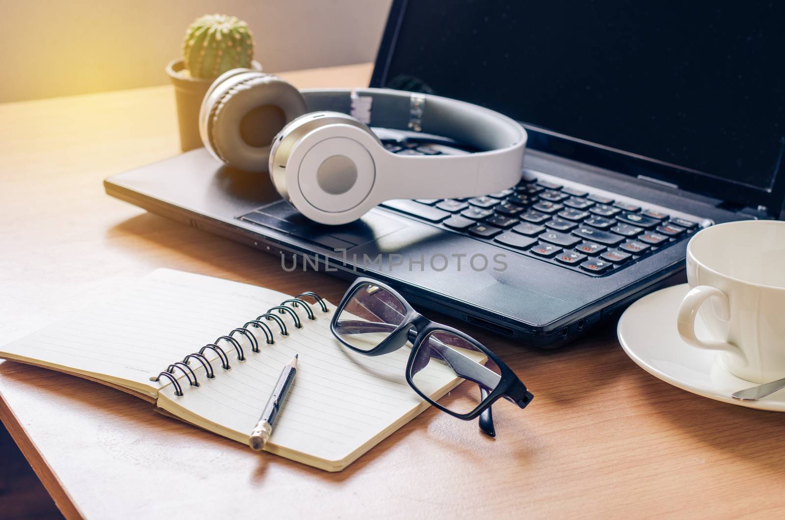 Headphone notebook on a wooden in work room