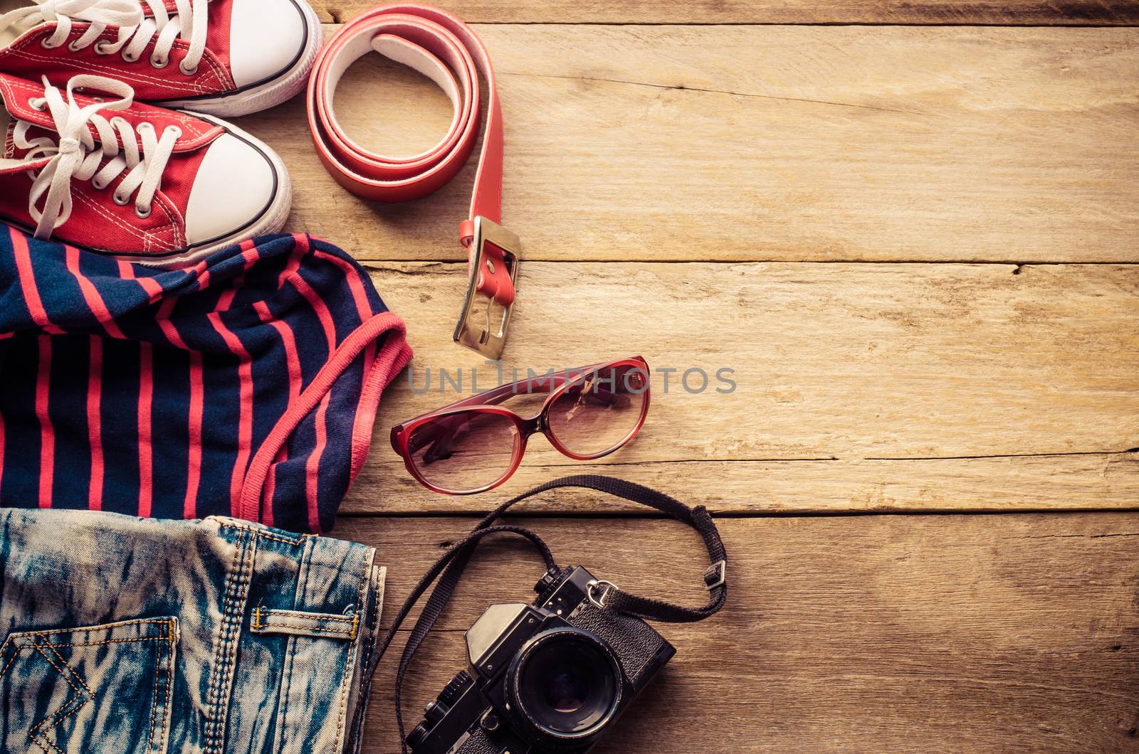 Travel accessories and costume on wooden floor