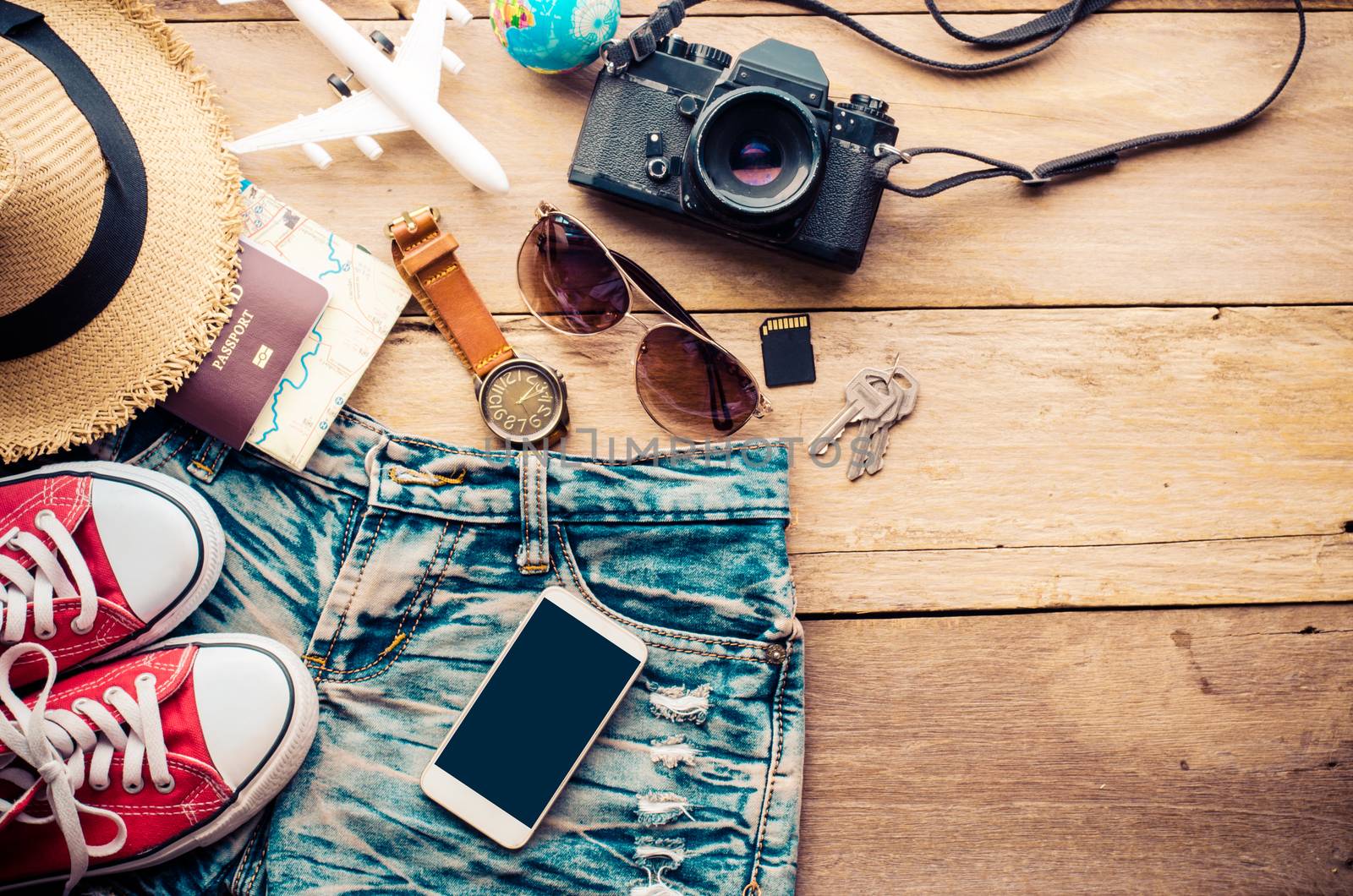 Travel accessories and costume on wooden floor