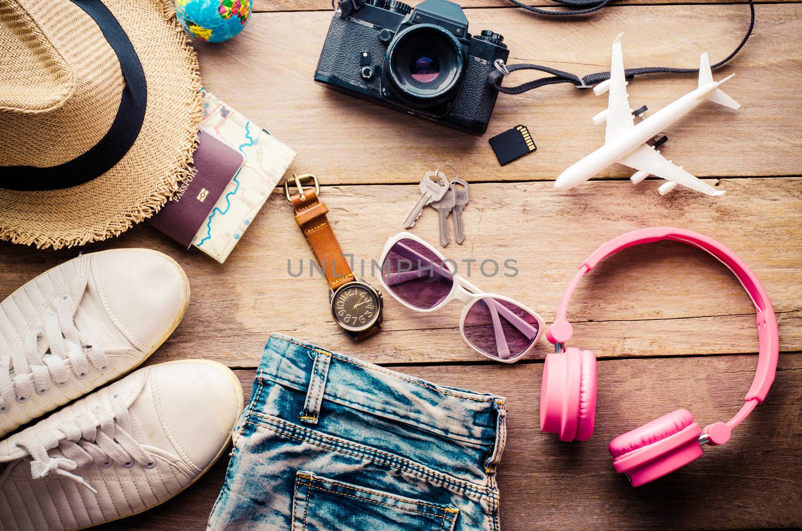 Travel accessories and costume on wooden floor by photobyphotoboy