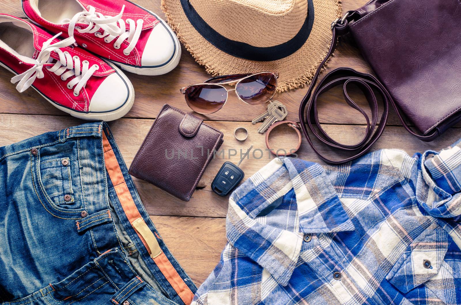 Clothing and accessories for travel on wood background