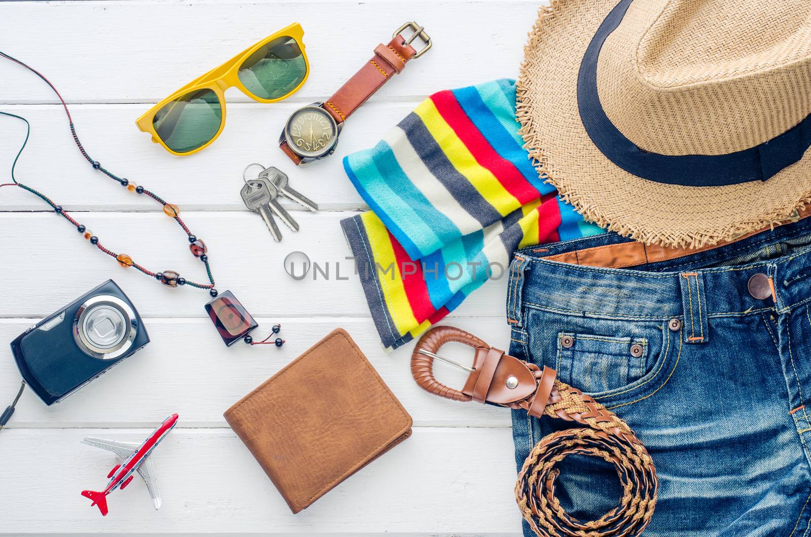 Travel accessories and costume on white background