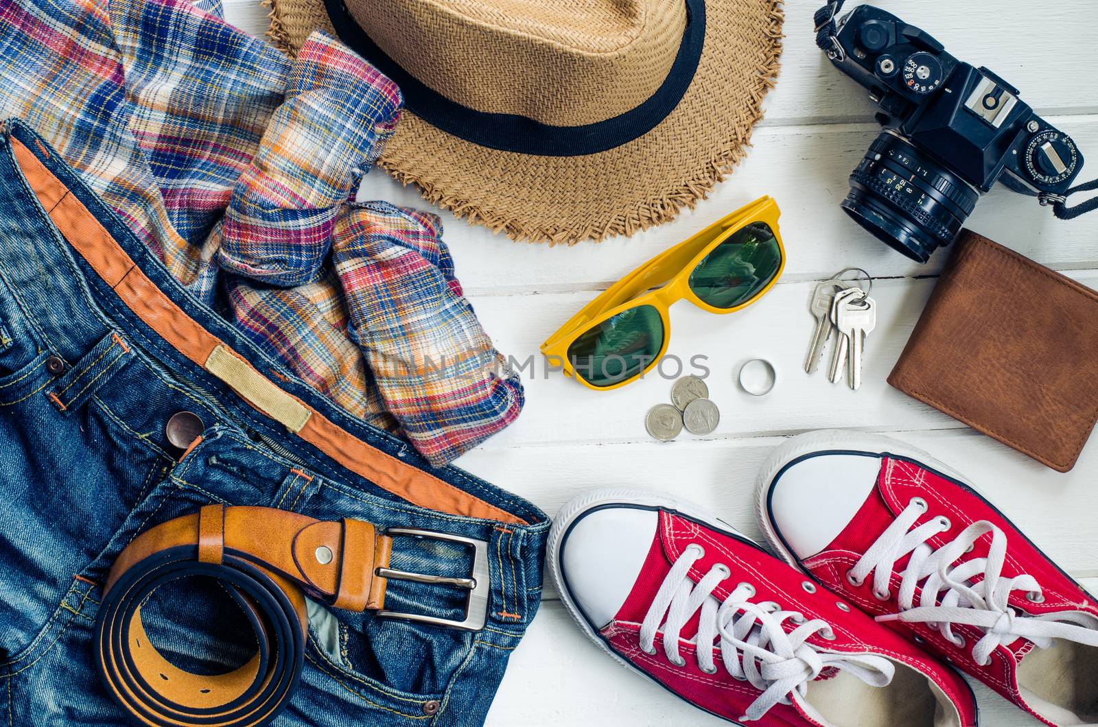 Travel accessories and costume on white background