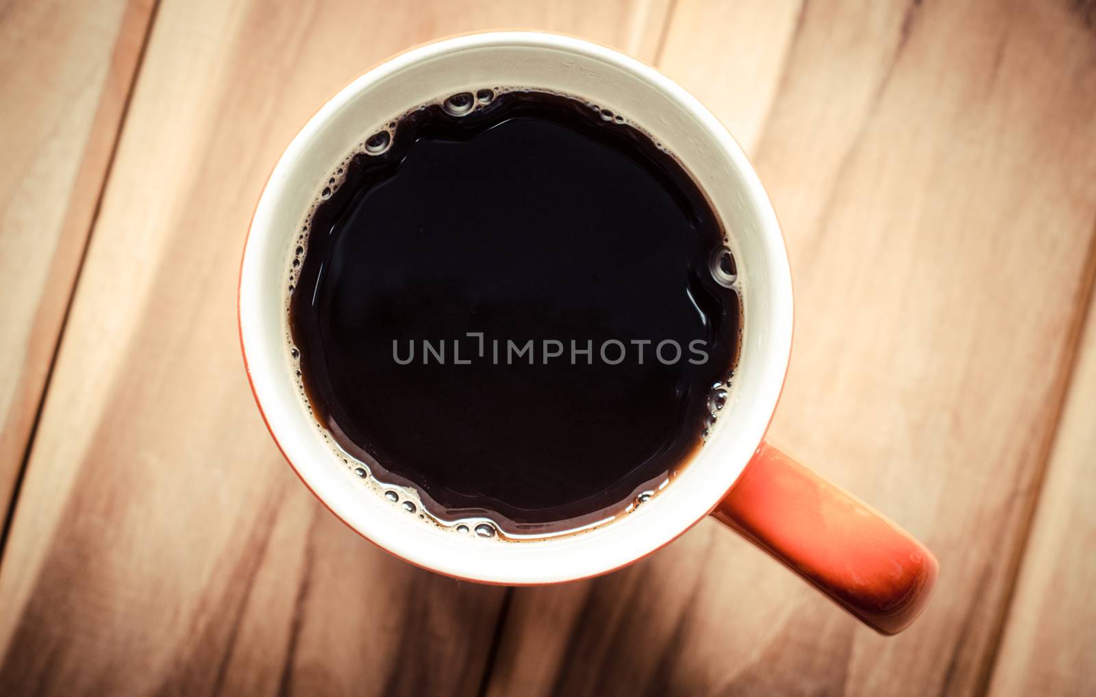 top view the coffee cup on the wooden floor.