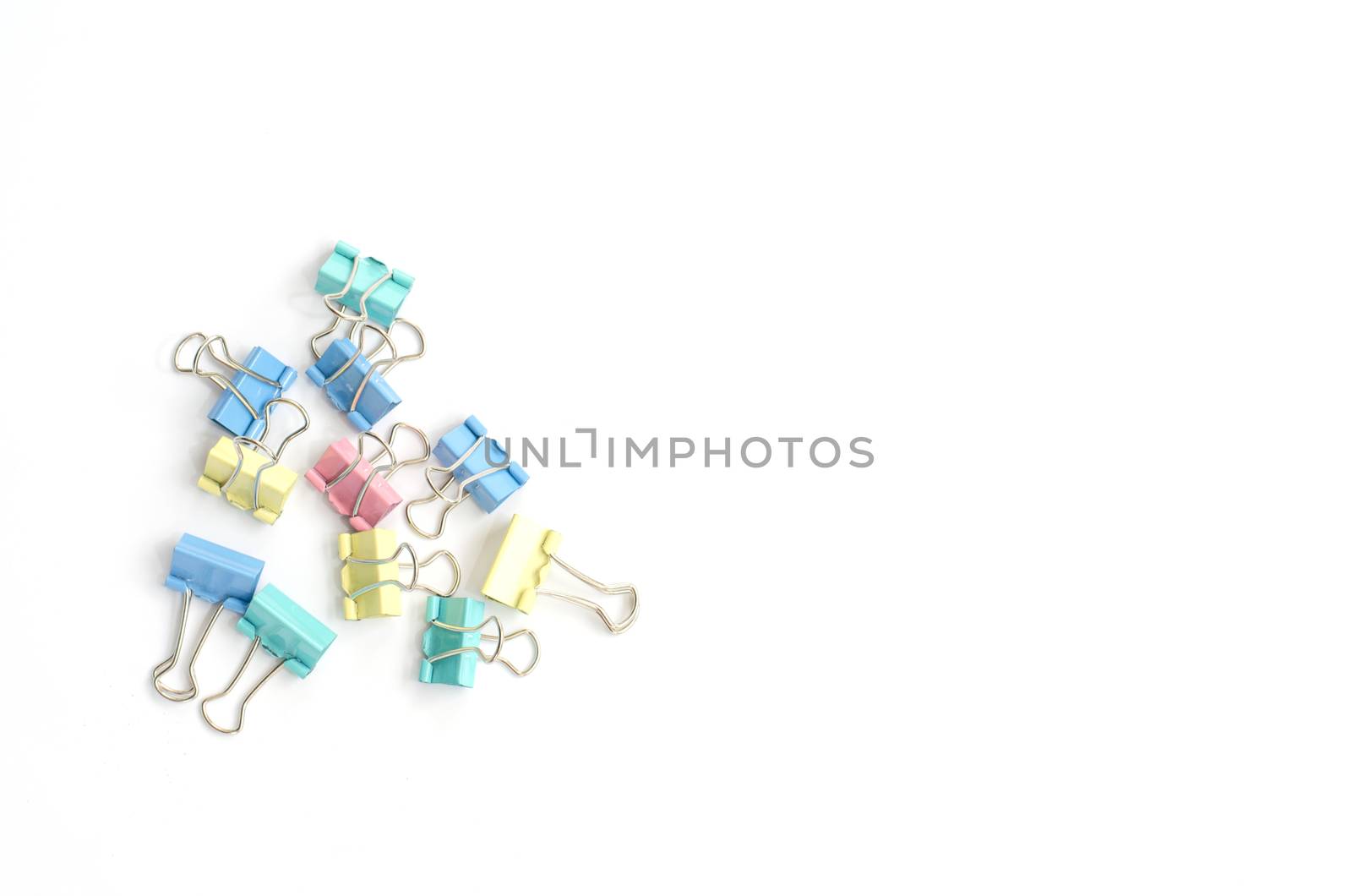 Colored paper clips on a white background.