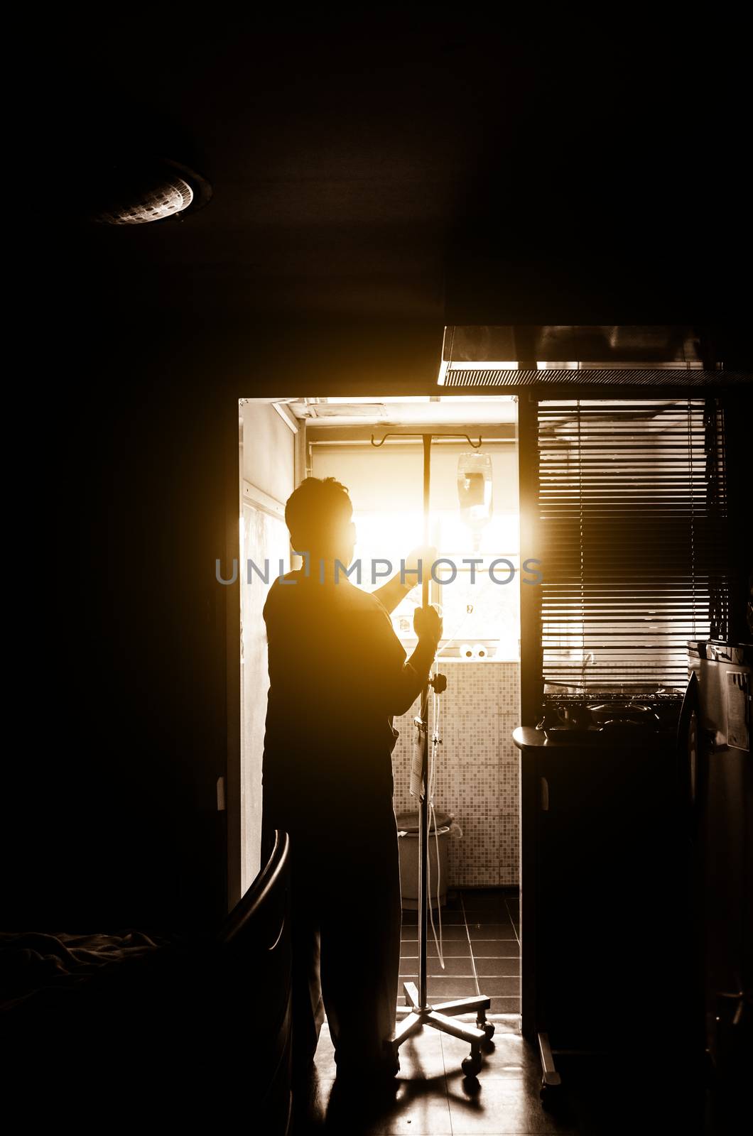 Shadow male patient waiting, hoping to recover from illness.