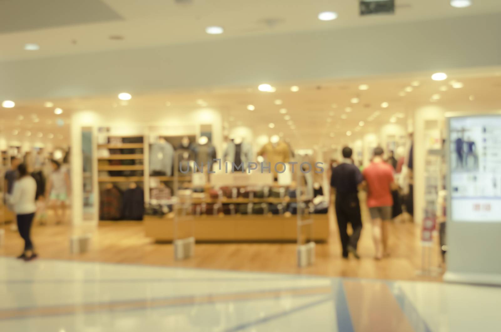 blurred image of shopping mall and people for background by photobyphotoboy