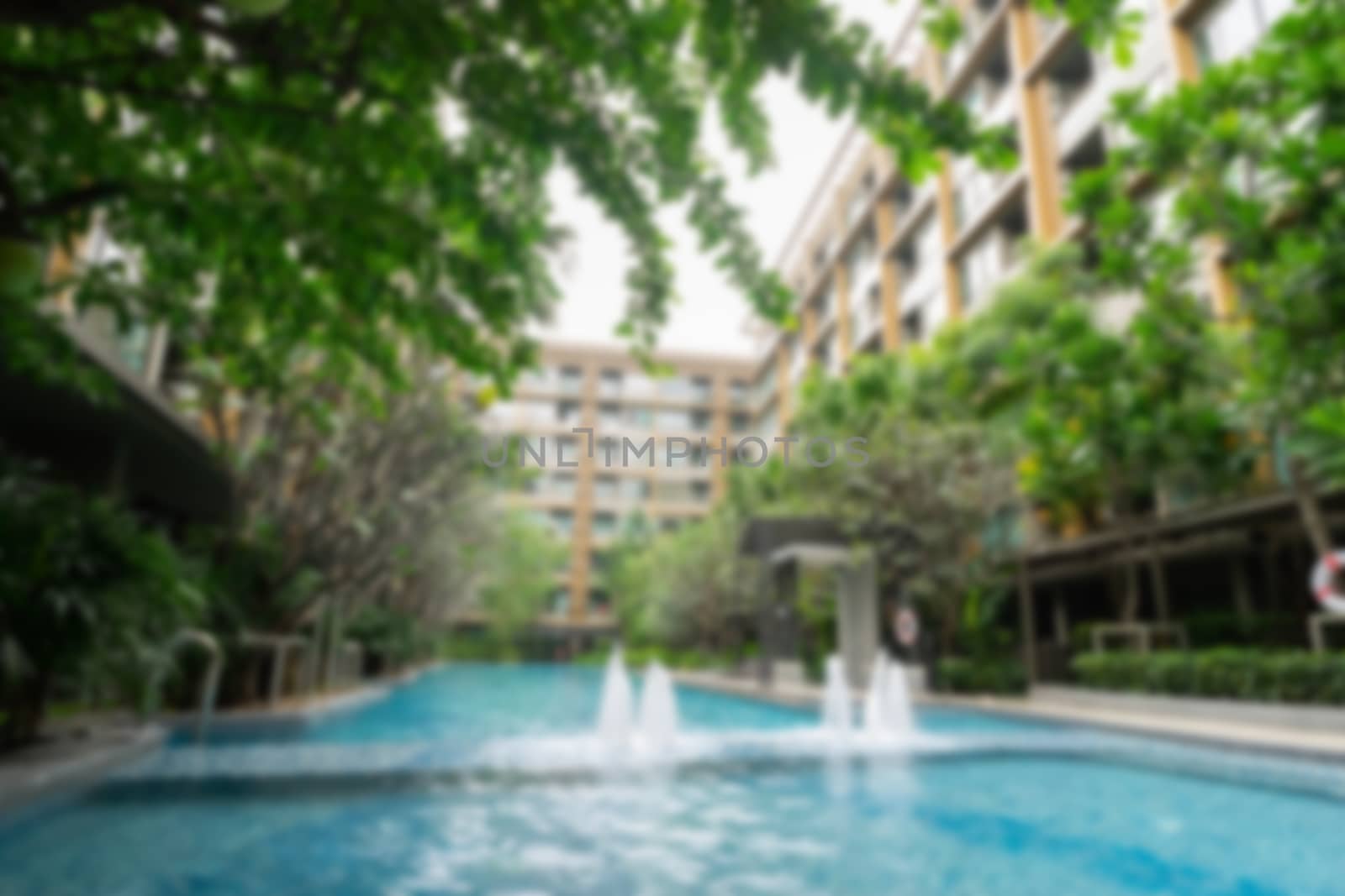 Swimming pool at the luxury resort morning scene, blurred.