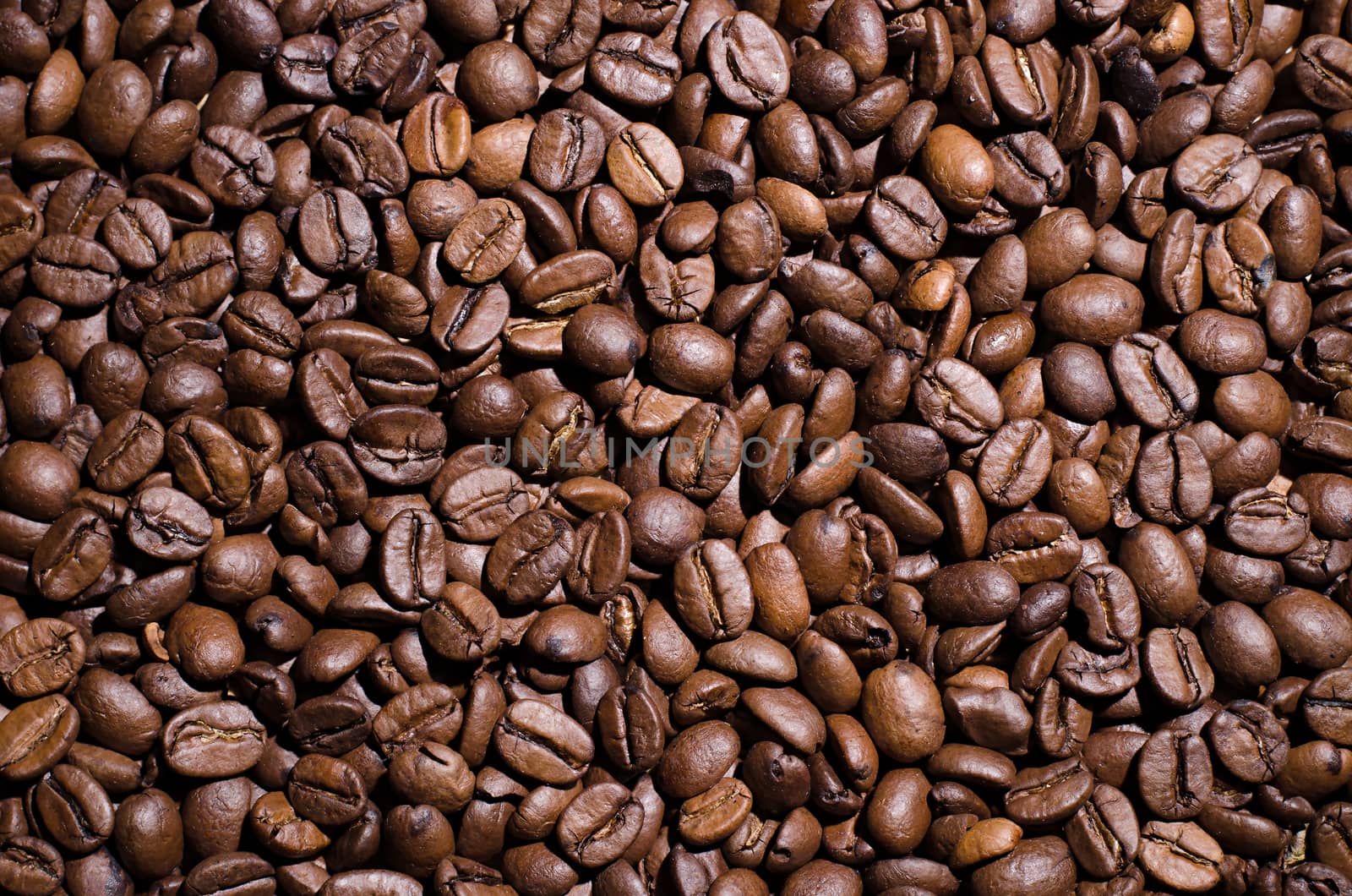 Background of coffee beans. Dropped brown coffee beans.