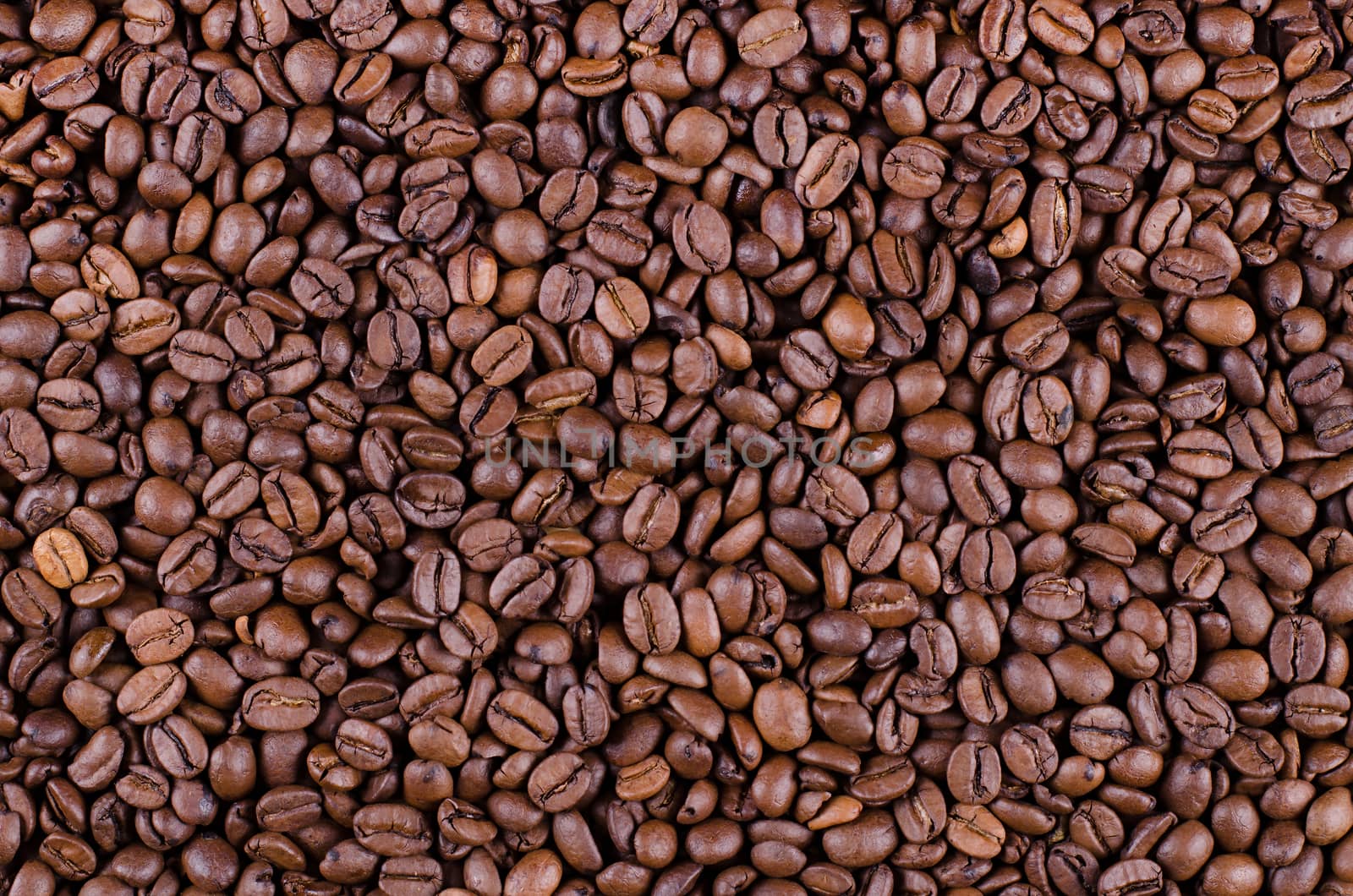 Background of coffee beans. Dropped brown coffee beans.