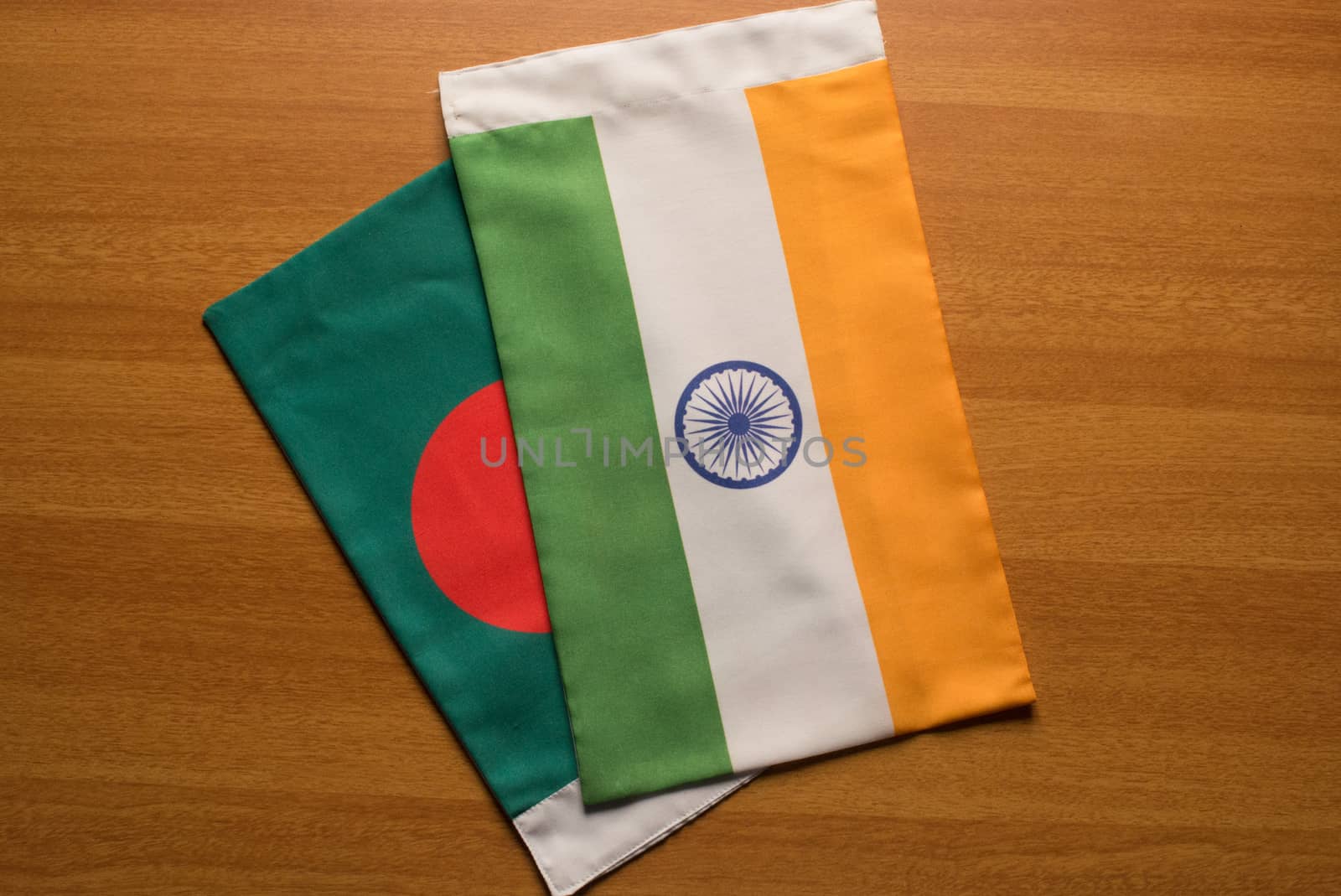 Bangladesh and Indian flags placed on table. by lakshmiprasad.maski@gmai.com