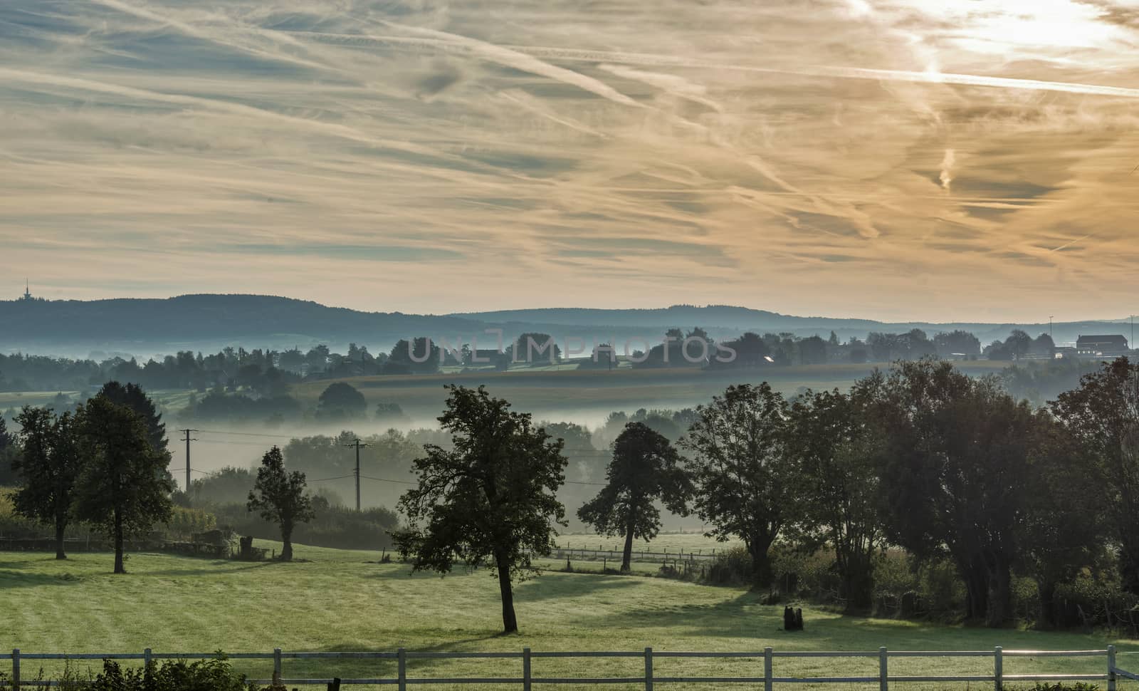 morning landscape with the hills in belgium with mist meadow 