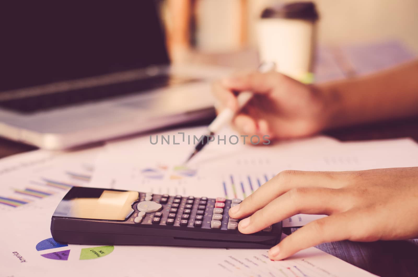 Businessman are working with a calculator and laptop. in office business concept 