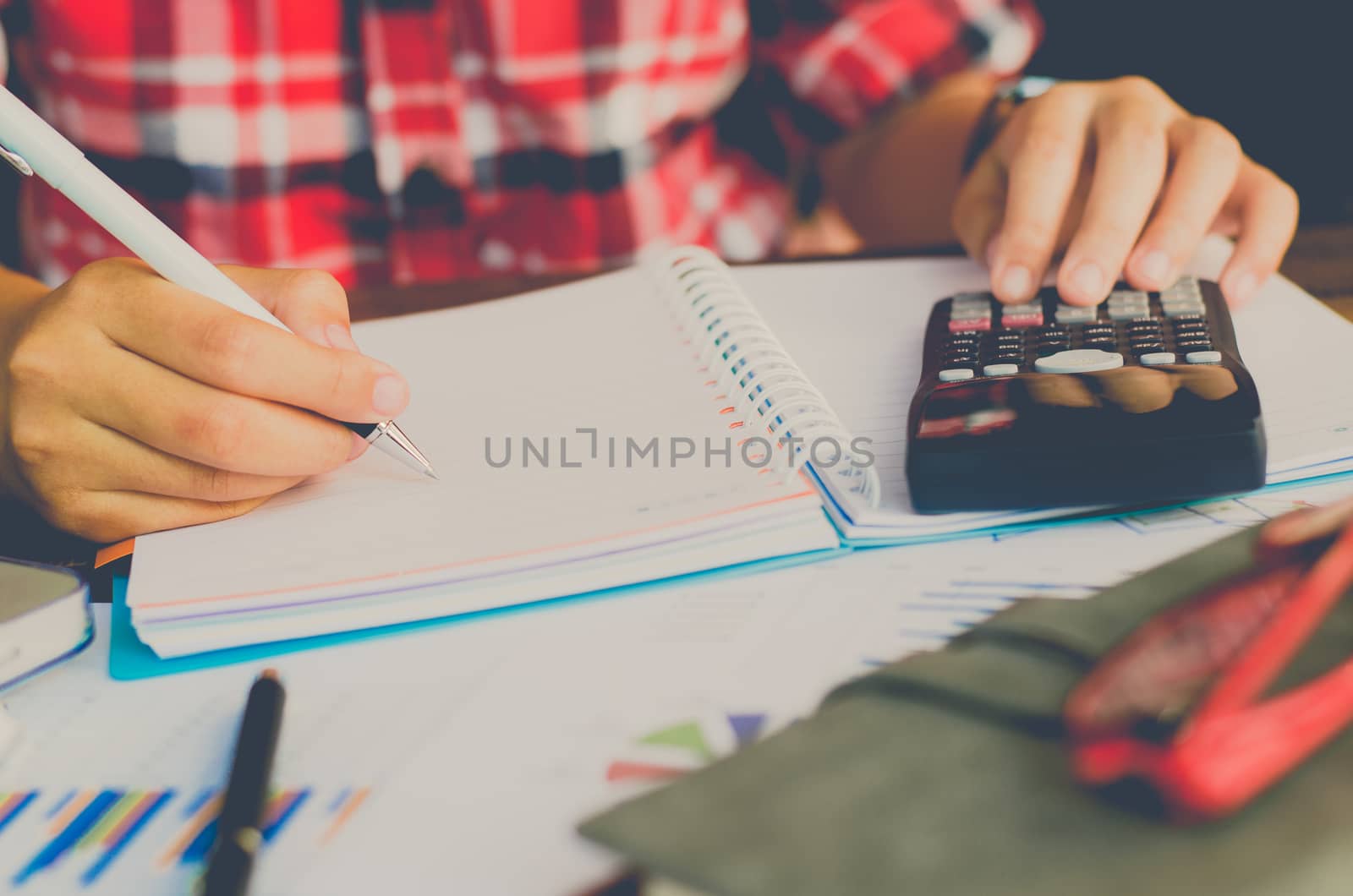 Businessman are working with a calculator and laptop. in office business concept 