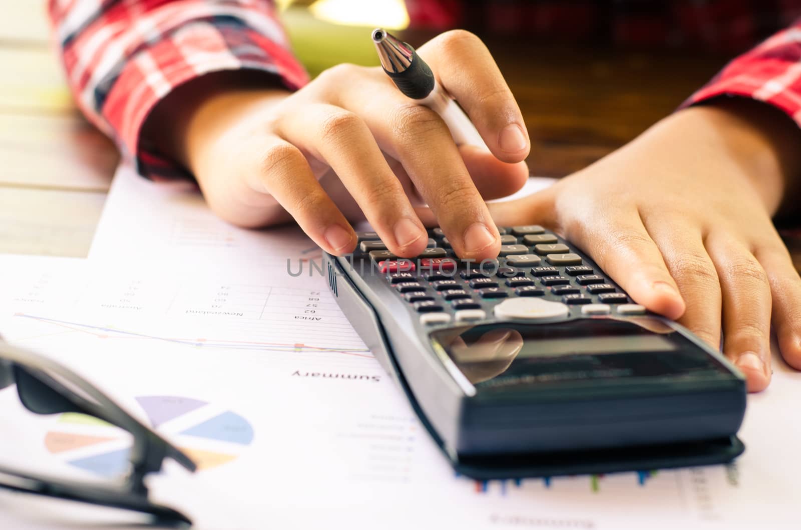 Businessman are working with a calculator and laptop. in office business concept 