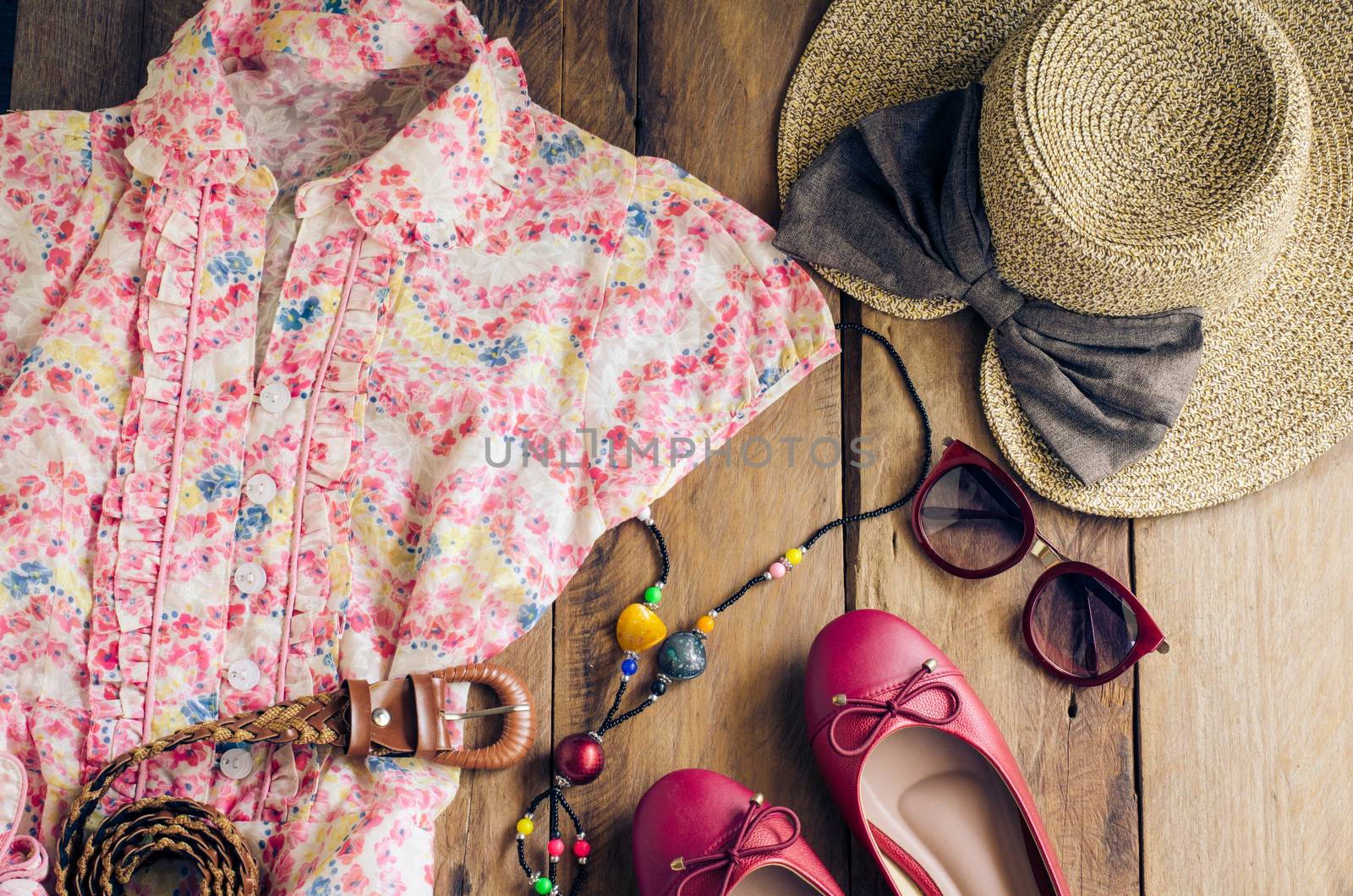 Clothing and accessories for women on wood floor for travel at holiday