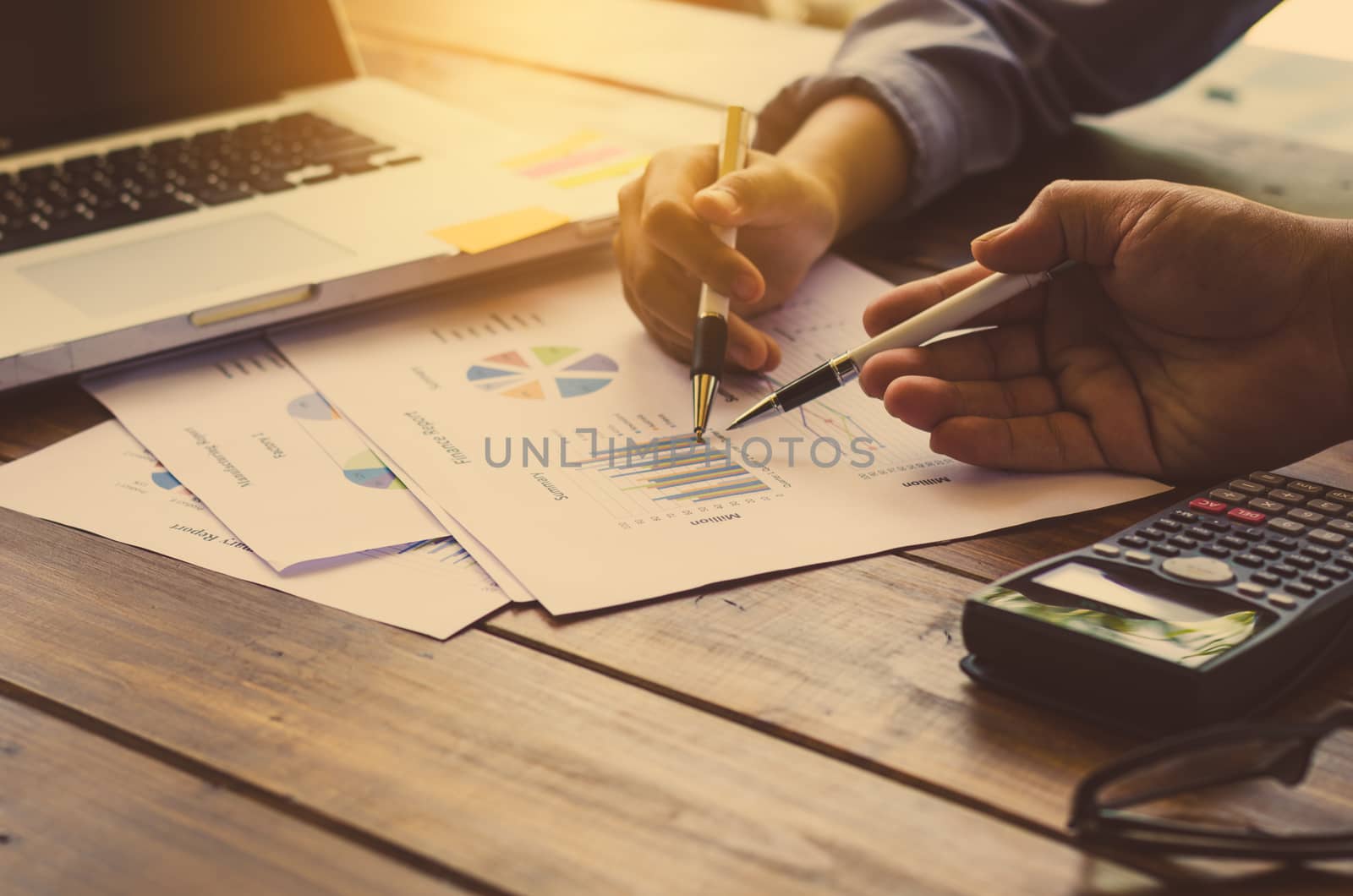 people are working with a calculator and laptop. in office business concept