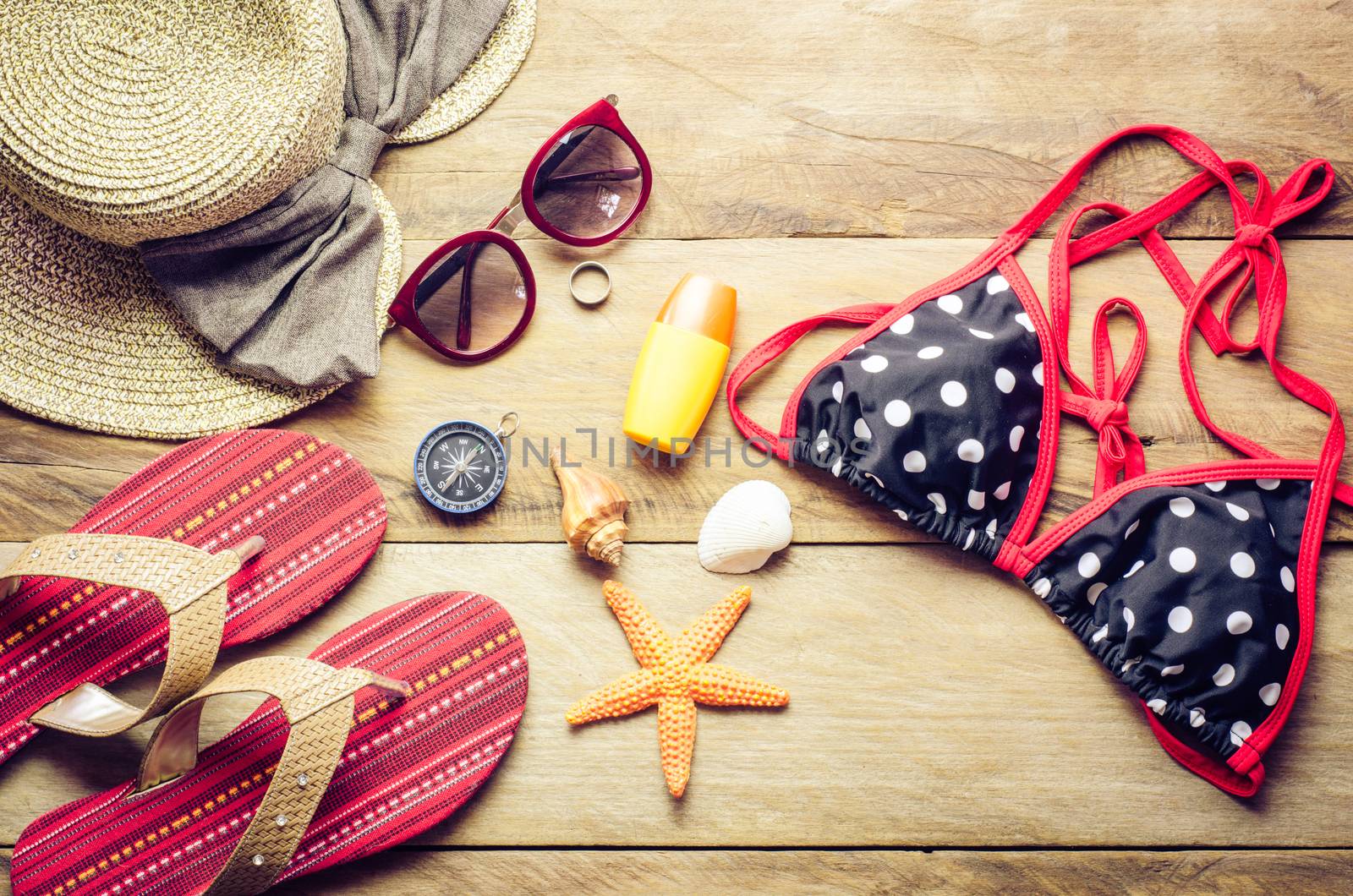 Beauty colorful bikini and accessories on wooden floor for trip on summer 