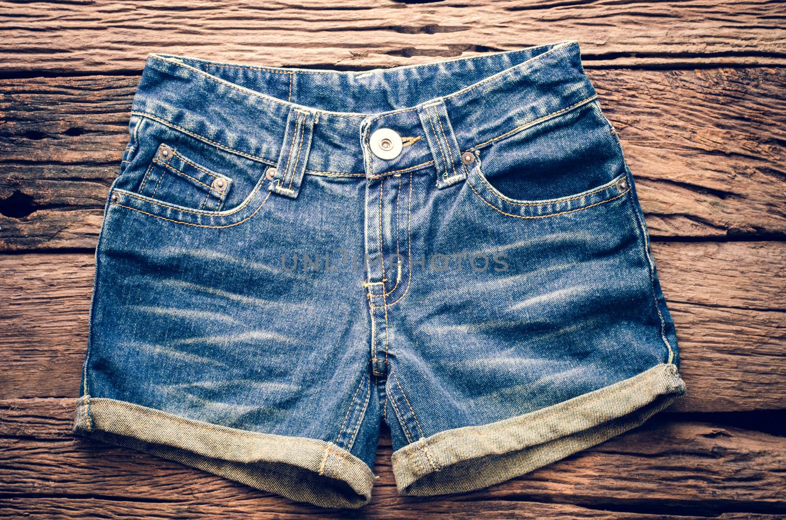 Jeans shorts on the wooden floor. 