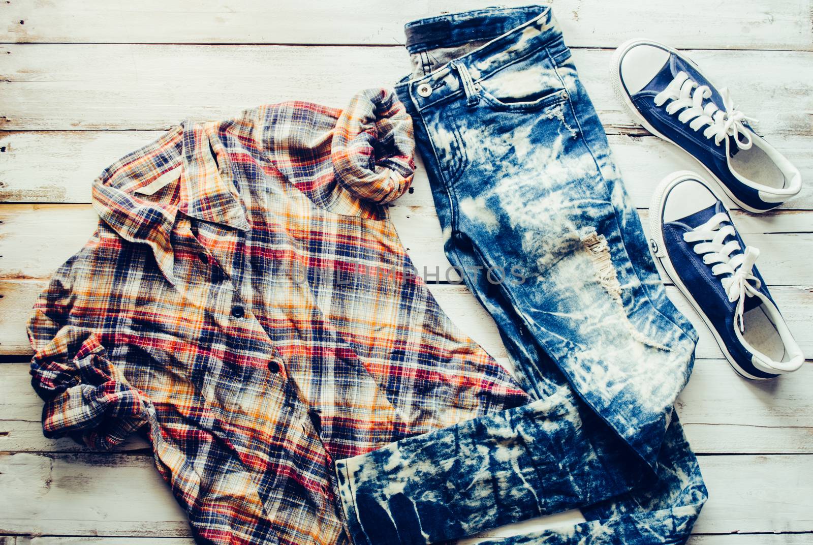 clothing for women, placed on a wooden floor.