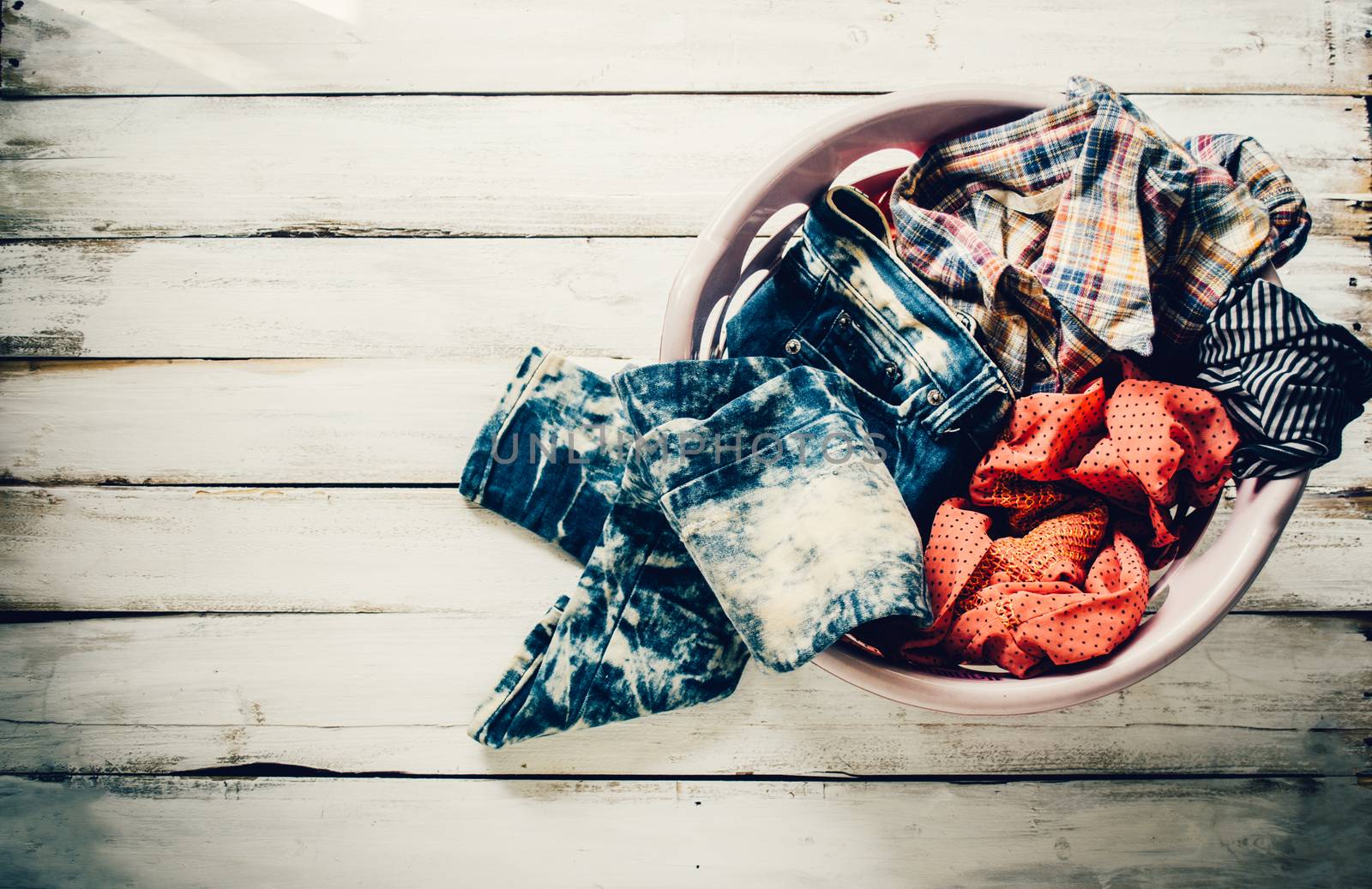 Clothes in the basket waiting to wash.